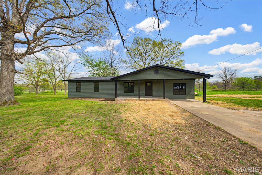 Completely remodeled four bedroom 2 bath home on 5 acres m/l with beautiful pond views. This home features a spacious living area, kitchen with adjoining dining space, and a functional layout for everyday living. The primary bedroom offers large windows overlooking the pond, along with a private bath and walk-in closet. An additional bedroom also features pond views, plus another bedroom for added space. A step down front room provides flexibility for a 4th bedroom, rec room, or office. Updates include new flooring, windows, siding, and more. Enjoy the back deck and nicely landscaped yard. Detached outbuilding previously used as living quarters includes electric, water, and septic—great for guest space or rental potential. Ideal for mini farm or country living.