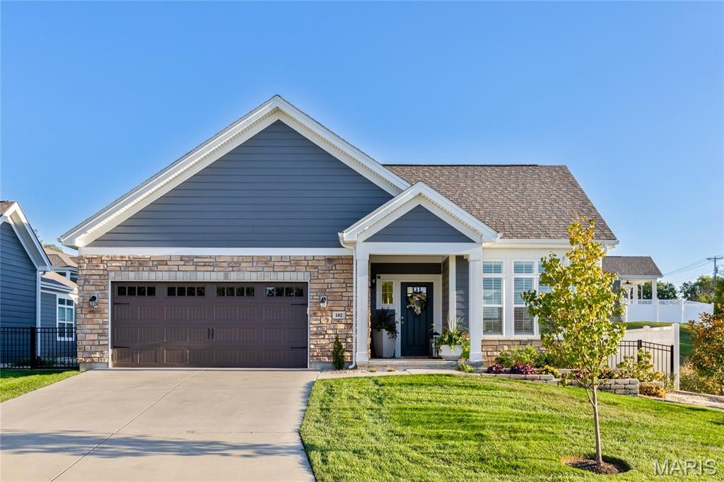 Beautifully designed ranch-style home in a premier Cottleville location within the highly sought-after Courtyards community. This thoughtfully planned residence offers an open, light-filled layout with stylish finishes and comfortable, low-maintenance living. The welcoming great room features large windows, custom built-ins, and flows seamlessly into the dining area and kitchen. The kitchen showcases quartz countertops, custom cabinetry, and KitchenAid appliances, creating an ideal space for both everyday living and entertaining. Just off the main living area, the bright sunroom with plantation shutters provides a relaxing retreat—perfect for morning coffee or evening gatherings. The main-level primary suite offers a spacious bedroom, walk-in closet, and well-appointed bath. A secondary bedroom and full bath provide comfortable accommodations for guests or a home office. Convenient main-floor laundry and an oversized two-car garage add to the home’s functionality. The finished lower level expands the living space with a large recreation room, plus a third bedroom and full bath—ideal for guests, hobbies, or additional living space. Enjoy the ease of courtyard-style living with lawn maintenance and snow removal included, all just minutes from the shops, restaurants, parks, and community events of charming Cottleville—a golf-cart-friendly destination known for its small-town atmosphere and vibrant lifestyle.