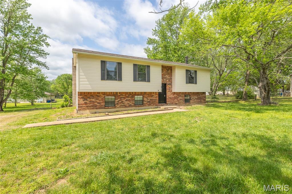 Spacious split foyer home on 1.15 acres m/l offering room to spread out inside and out. The main level features a comfortable living room, a generous kitchen with adjoining dining area, and three bedrooms including a larger secondary bedroom. A full bath completes the main level. The lower level adds extra living space with a family room featuring a wood-burning fireplace, a second full bathroom, and a dedicated laundry room. Outside, you’ll appreciate the privacy and space of the acreage along with a two-car garage for convenience. If you’re looking for a home with usable space, indoor and outdoor, this one is worth a look.