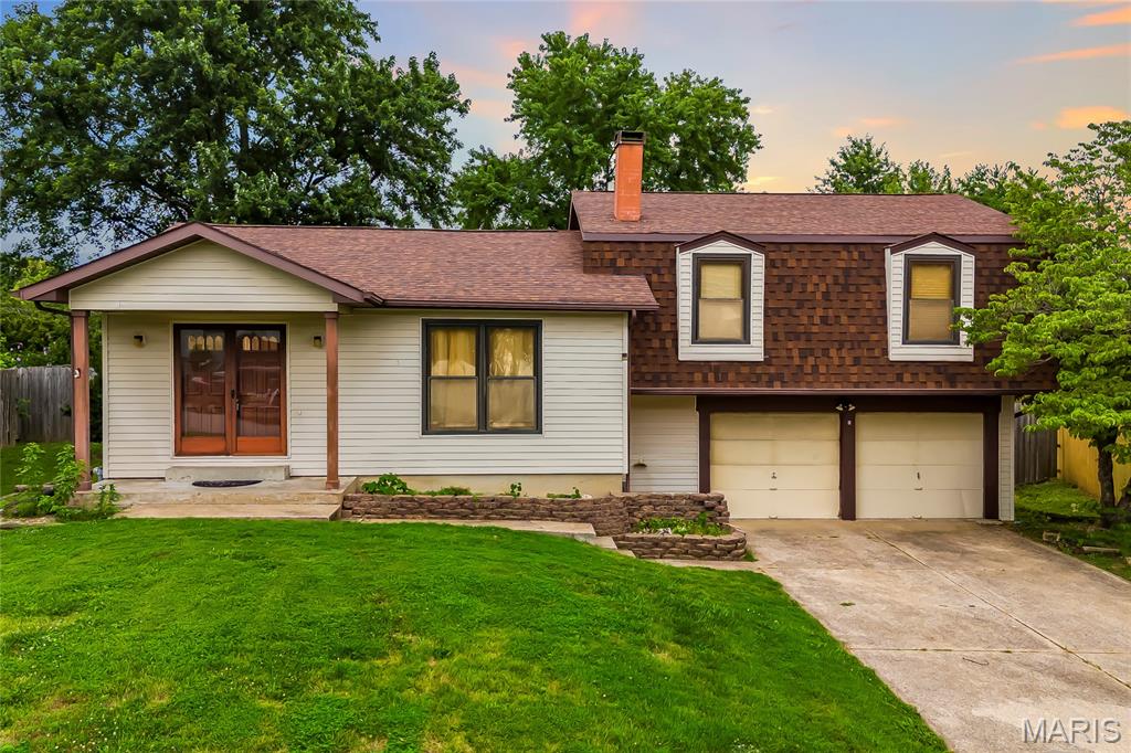 Charming home sitting on a .33 acre lot in the popular subdivision of St Peters Hills! This home boasts 3 bedrooms, 3 bathrooms, and 1,989 square feet of living space. 

The front door opens to the spacious living room with a wood burning fireplace, vaulted ceiling, and opens to the kitchen.

The second floor features the primary bedroom with a bathroom, two additional bedrooms, and a hall bathroom. 

The finished lower level boasts two sleeping rooms, a bathroom, and ample storage space. 

Relax outside on the covered, concrete back patio, and enjoy the mostly level, fenced in backyard! Other highlights include: 2 car attached garage and a covered front porch. 

Location could not be better – close to major highways, restaurants, shops, and schools! Property is to be sold as-is.