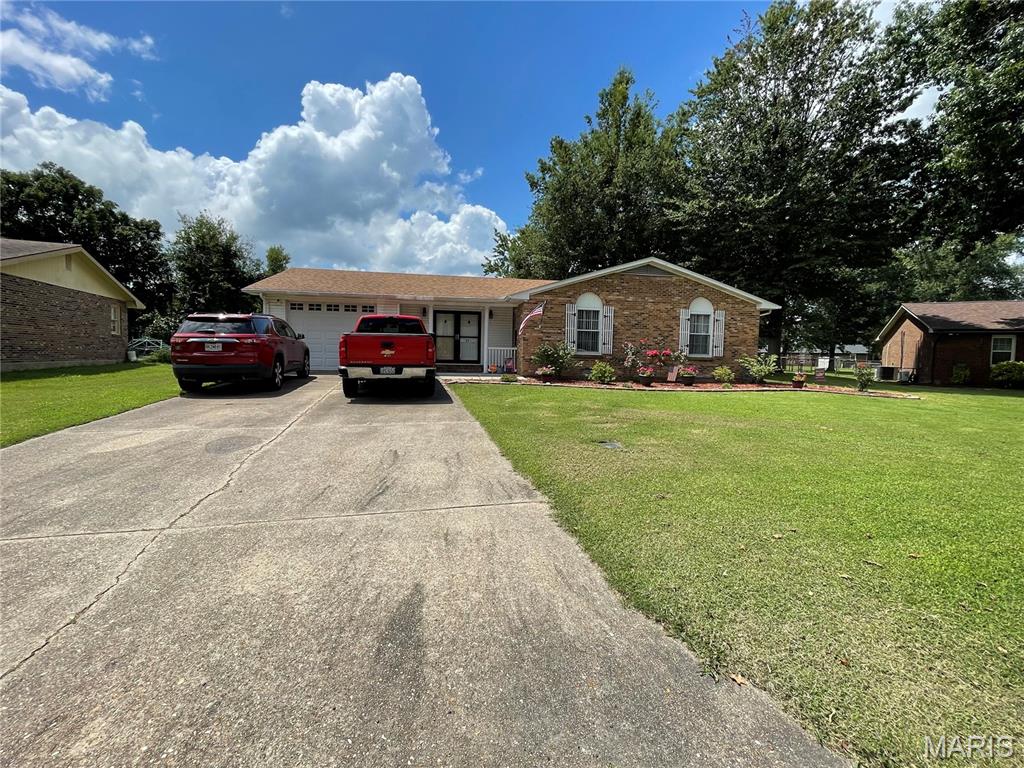 This home offers plenty of space for a growing family, inside and outside. With over 2000sqft of living space inside you will find 3 bedrooms and 2 updated bathrooms. Updated kitchen with plenty of space for a formal dining room table. A family room and spacious den that offers a beautiful wood burning fireplace. Laundry room with plenty of cabinets for all your storage needs. This home offers a 1 car attached garage PLUS a 2 car detached garage with concrete floor, electric, and baseboard heating. Large, fenced back yard with a great patio space for grilling and entertaining guest. This home is move in ready, call today to schedule of private viewing!!