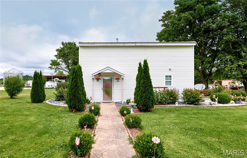 Who is ready to move to the country? Welcome home to your 7 acre retreat! No known restrictions. 2bd, 2bth older home.  It has had some nice updates, come and walk through to see for yourself. The kitchen is super nice for the cook in the family, There is free standing wood stove for those chilly nights, and a formal dining room that has French doors that lead you out to a perfect patio setting w a fire ring.
Outdoors also there is a 30x40 garage (detached).  There  are sidewalks and patios and so many beautiful flowers. Gardening is easy with the raised beds. The back patio is where I'd spend most of my time!
Horses have been kept here in the past, fence just needs a little work, there s a small lean-to for them to shelter, behind the detached.
Deer hunters check this out!  4 deer stands are already in place and will stay.  The Seller has taken some nice deer out of the woods. There are a couple cute little stick huts built by the Seller in the woods for the kids to explore. He has a path mowed through the back for convenience.
You know it's time! Check it out.
