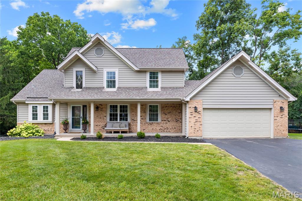 Exceptional brick 1.5 Sty. Located in a highly desirable neighborhood with award-winning Francis Howell Schools. Open floor plan features custom amenities & updates throughout including oak hardwoods, soaring ceilings, crown molding & skylights. Impressive 2-sty foyer leads to formal dining room with built-in bookcases and vaulted great room with floor-to-ceiling brick fireplace flanked by full-height windows that overlook wooded ground. Chef’s kitchen with granite countertops, staggered cherry cabinetry, stainless steel appliances & 6’ peninsula adjoins light-filled breakfast room with atrium door to sunroom. Primary bedroom suite with walk-in closet & luxury bath offers an appealing retreat. The 2nd floor extends the living area with 3 additional bedrooms & hall full bath. Lower Level entertainment space includes recreation room, office & full bath. Situated on a private .47-acre cul-de-sac lot with tree-lined backyard. Downtown Cottleville is just a short walk or cart ride away.