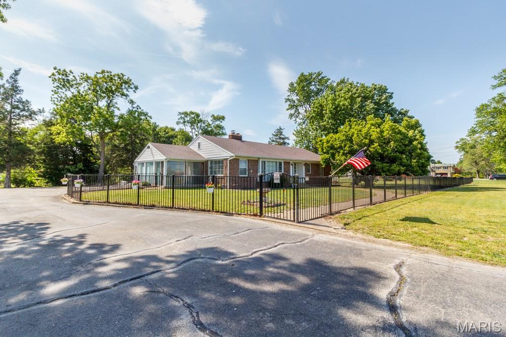 RARE OPPORTUNITY TO OWN A PROPERTY THAT WOULD MAKE A GREAT COMMERCIAL SPOT OR EVEN THAT PERSON THAT DESIRES CONVENIENCE! Located on approximately 1.5 acres with great highway visibility, this beautifully maintained 3-bedroom, 2-bath brick home that perfectly blends comfort, space, and charm. From the moment you arrive, the classic brick exterior and inviting front entrance set the tone for what awaits inside. Step in to discover multiple spacious living areas designed for both everyday living and entertaining, including a cozy living room featuring warm flooring, a stunning fireplace, and built-in shelving that adds both character and functionality. Large windows throughout the home allow for an abundance of natural light, creating a bright and welcoming atmosphere in every room. The kitchen offers generous cabinetry, ample counter space, and stainless steel appliances, making meal prep and gatherings both easy and enjoyable, while the adjoining dining area provides a warm and inviting space for family dinners or hosting friends. One of the standout features of the home is the incredible sunroom surrounded by windows, filling the space with natural light and offering the perfect spot to relax, entertain, or enjoy peaceful views of the yard year-round. Outside, the property continues to impress with a spacious yard and fenced area that provides privacy and plenty of room for pets, gardening, or outdoor gatherings. With its solid construction, functional layout, and inviting character throughout, this home offers the perfect blend of comfort, space, and timeless appeal.