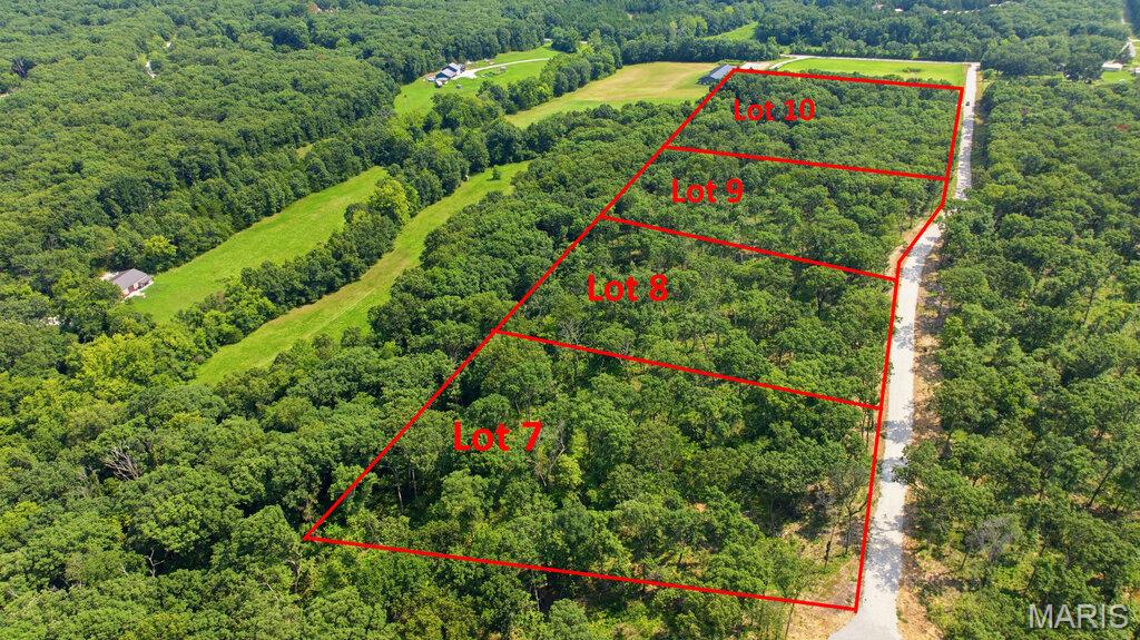 3.07 Beautiful, wooded acres located just minutes from I-70 and conveniently situated just off blacktop frontage. This peaceful property offers the perfect setting to build your dream home or barndominium while enjoying privacy, nature, and easy access to nearby amenities. Lots range from approximately 3 to 5 acres and are subject to minimal restrictions. No mobile or modular homes, junkyards, or hog farms are permitted. Cuivre River Electric will be available upon completion of engineering and installation by the developer. Each lot will require a private well and septic system.