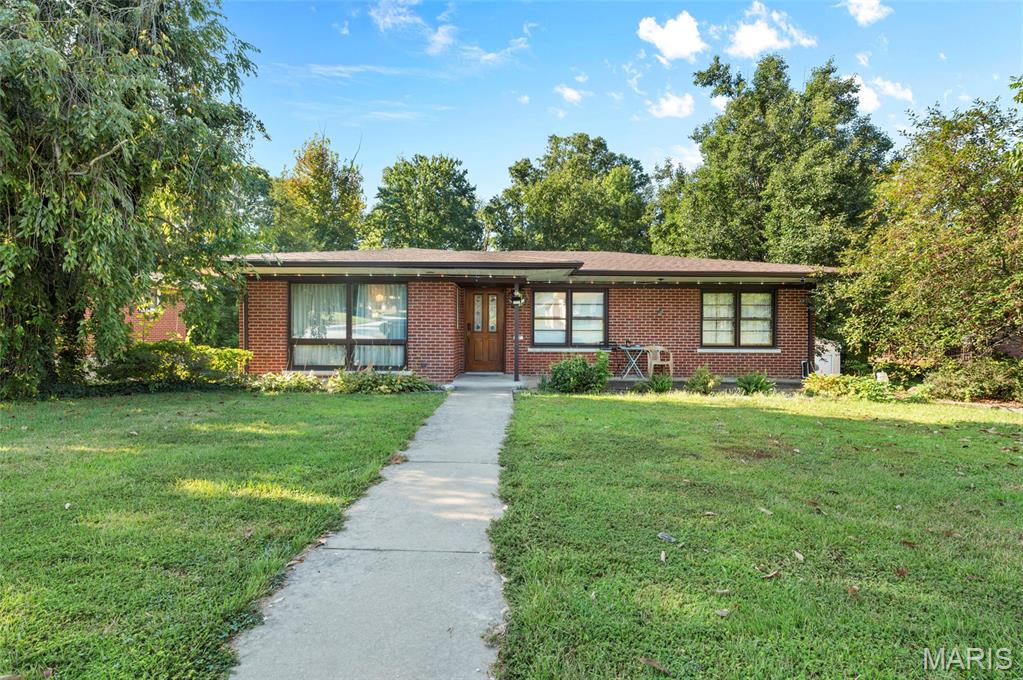 Welcome home to 67 Cheshire! This beautifully maintained full brick ranch shows true pride of ownership with a new roof (2023) and updated systems throughout. Step inside to a generous living room flowing into an attached dining room—electric fireplace stays! The kitchen impresses with warm hickory cabinets, quartz countertops and backsplash, and stainless steel appliances. Refrigerator new in 2026.  Original hardwood flooring, recently refinished, runs throughout the main level. Sliding glass doors lead to the private, wooded backyard, now fully enclosed with a new black aluminum fence, and a brand new 20x9 composite deck with a screened-in porch underneath—perfect for entertaining in any season.  The main level offers three bedrooms, including a primary suite with a half bath, plus two additional bedrooms sharing a full bath off the hallway—don't miss the vaulted ceilings and abundant natural light. The double walkout lower level adds even more living space: a fourth bedroom with new carpet, an entertainment room with wet bar, a media room, a full bath, and ample storage.  Additional updates include a new electrical service panel with smart breakers and a newer whole-house water filtration system with water softener. Solar panels are installed through the IL Shines Program with a transferable lease at $89/month—buyer to assume. Close to everything Belleville has to offer—book your private tour today!