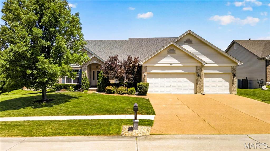 Exceptional 4-bedroom ranch home in Wentzville featuring over 2,000 square feet of thoughtfully designed living space, a finished walkout lower level, and an oversized 3-car garage. Situated on a beautifully maintained lot with a fenced backyard, irrigation system, aggregate driveway, and a brand-new roof installed in 2024, this home offers the perfect blend of comfort, style, and functionality.
Inside you’ll find hardwood flooring throughout the main living areas, soaring 9-foot ceilings, 5” baseboards and a vaulted great room anchored by a stone fireplace with gas logs (can be woodburning too). The open-concept layout flows into the spacious kitchen and breakfast room, complete with 42-inch maple cabinetry with crown molding, ceramic tile backsplash, breakfast bar, and bay windows that flood the space with natural light.
The dining room is enhanced with three-piece crown molding, creating the perfect setting for gatherings and special occasions. Just off the breakfast area, a new deck overlooks the private fenced backyard, while the walkout lower level leads to a large patio, providing multiple outdoor spaces for entertaining and relaxation.
The spacious primary suite features a stepped tray ceiling, bay window, walk-in closet, and a luxurious ensuite bath with marble-surround soaking tub, separate shower, and dual vanity. Main-floor laundry adds everyday convenience.
The finished walkout lower level expands the living space with a large family and recreation area, a fourth bedroom, and a full bath—ideal for guests, a home office, multi-generational living, or entertaining.  Seller is providing Guard Home Warranty Systems Package for added peace of mind.
Conveniently located near top-rated Wentzville schools, parks, shopping, dining, and major highways, this move-in-ready home combines desirable upgrades, flexible living space, and outstanding curb appeal. Don't miss your opportunity to own this exceptional ranch home with a finished basement, fenced yard, and premium features throughout.