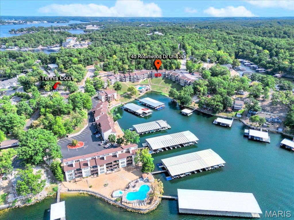 Fully furnished Condo with 10x24 Boat Slip (B8) w/lift in desired Robinwood Condominiums - perfect family getaway, rental investment (rentals are allowed) or live Lake Life EVERYDAY!  2 Bed/2 Bath unit offers 958 sq ft w/breathtaking views of the beautiful Lake at the 10mm & one of the salt water pools.  Community offers- 2 pools which 1 is heated, hot tub, clubhouse which offers a party room and work out room, tennis courts & docks.  Dock is a short walk from this condo and is also protected which keeps the cove calmer too.  Only 8 steps from parking lot to the landing!  Open floor plan is perfect for entertaining & families.  Kitchen has NEW Stainless Steel Refrigerator and Range Hood and NEW LVP flooring in the kitchen area.  Kitchen also offers new kitchen faucet and large breakfast bar w/seating, ample cabinets & counter space.  Spacious Living Rm has floor to ceiling stone fireplace (no wood allowed/can easily be converted to electric) perfect for fall and winter months at the Lake.  Triple glass floor to ceiling sliding door to the covered composite deck offers lots of natural light & that gorgeous Lake View!  NEW ceiling fan on the balcony area as well.  Spacious Primary Bed has sliding door leading to balcony, walk-in closet & en suite full bath.  Nice size 2nd Bed, hall bath and laundry area w/washer/dryer that stay with condo.  Carpets are freshly cleaned.  Property is minutes from EVERYTHING- The Strip, restaurants (Shady Gators, H. Toad's Frankie & Louie's), The Cove Golf - Beautiful 18 Hole Course, shopping, entertainment (mini golf, The Malted Monkey).  Included in the LOW monthly HOA fee of $445 a month is Water, Sewer, Trash, Cable TV, Internet, Maintenance of Pools, Docks,Tennis / Sport Courts, Grounds & Roads.  Don't miss this ONE!