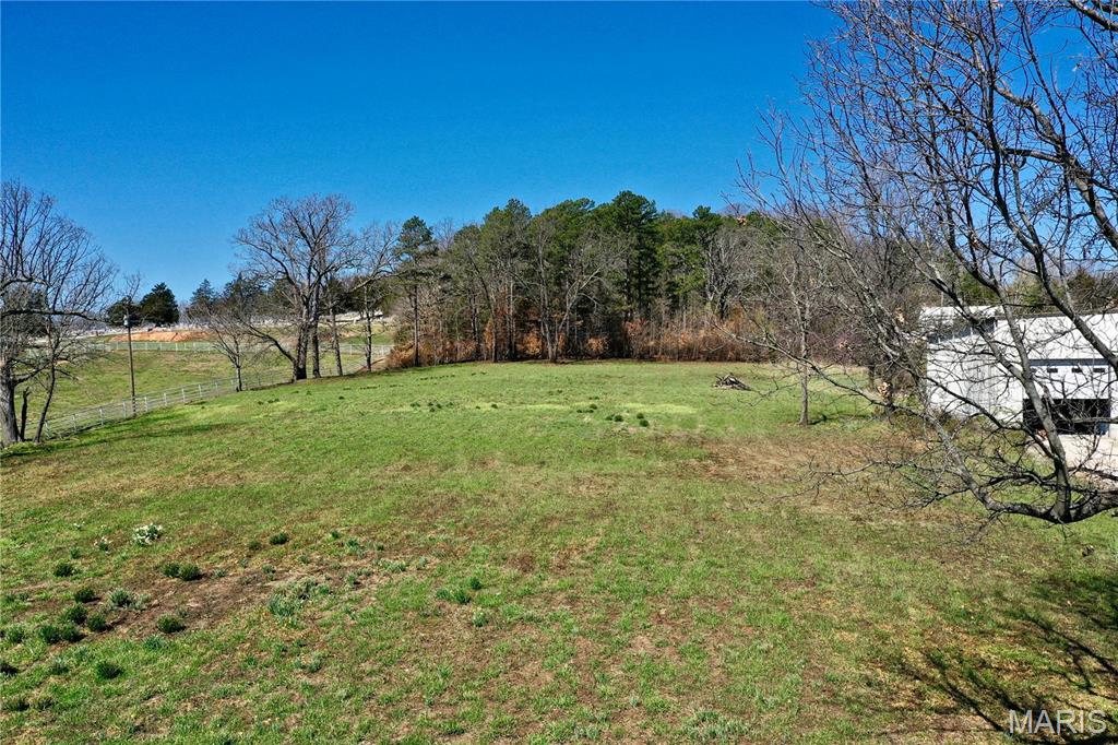 Welcome to 4.93 acres of prime real estate just beyond the city limits, offering endless possibilities for development or personal use. Situated conveniently with approximately 160 feet of road frontage on state Hwy P, this expansive parcel is poised for opportunity. City utilities lie approximately 400 feet away, adding convenience and accessibility for future endeavors. Its proximity to the elementary school across the road and the city park just a quarter mile away enhances its appeal for residential or commercial ventures. Don’t miss out on this rare chance to shape your vision on this versatile piece of land!