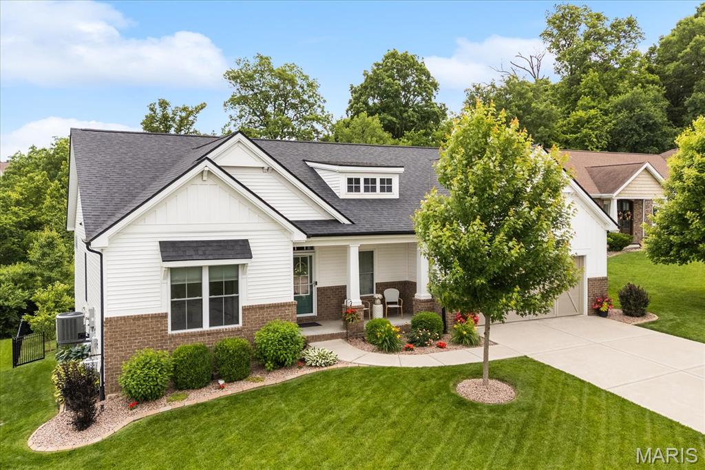 Curb appeal. Privacy. Cul-de-sac.  Built in 2018 by Laurie Homes, this 5-bed, 3-bath walk-out ranch (plus an office) sits on a quiet cul-de-sac lot overlooking a lush, wooded backyard.  Inside, the great room makes an immediate impression with a floor-to-ceiling wood accent wall, gas fireplace, and a sliding glass door wall of windows that opens to the composite deck and private setting beyond. The kitchen is equally well done with white custom cabinetry, a contrasting wood island, upgraded appliances and a walk-in pantry. Thoughtful details really set this kitchen apart with floating shelves, under cabinet lighting, a concealed microwave and a lift cabinet for a stand mixer.  Escape to the primary suite where you will enjoy a custom tiled shower, soaking tub and dual walk-in closets. The finished lower-level with kitchenette adds an entire second living space ideal for guests or multi-generational living. Additional features include landscape lighting, front/back irrigation system, professionally installed permanent LED house lights, whole house humidifier, and so much more.  Nestled in scenic Tanglewood, with nature paths, stocked ponds, a playground, and miles of sidewalks for walkers and joggers plus golf-cart friendly streets. All just 20 minutes from downtown St. Louis and Scott AFB.