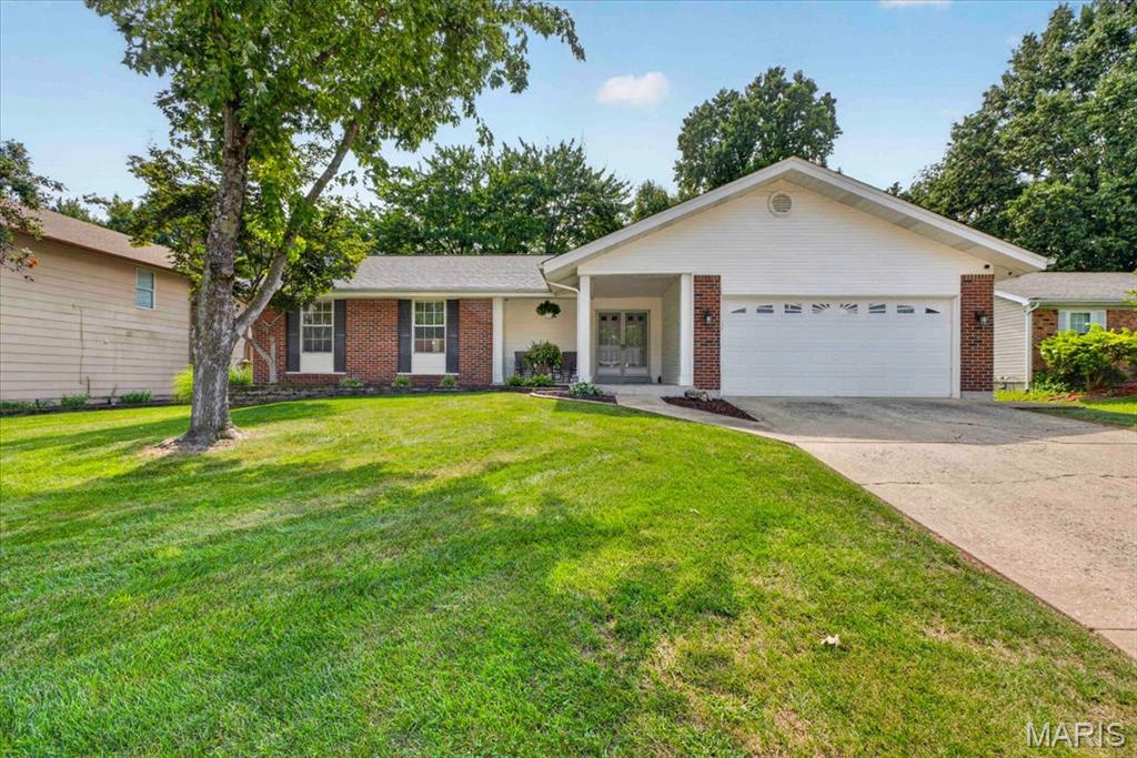 Curb appeal, modern updates, and a prime St. Charles address! Nestled on a quiet, tree-lined street, this immaculate ranch welcomes you with a wide covered porch and classic brick facade. Inside, the vaulted great room features gleaming hardwood floors, a floor-to-ceiling masonry fireplace, and picture-window views overlooking the large, level, fully fenced backyard—offering plenty of space for kids, pets, entertaining, or simply relaxing outdoors. The sun-filled eat-in kitchen features refreshed cabinetry, stainless steel appliances, and solid-surface countertops. An oversized laundry/mudroom keeps life organized and opens to the two-car garage with additional storage bump-out. Down the hall, you'll find two generous bedrooms, an updated hall bath, and a private primary suite with a renovated bath and custom walk-in closet. The spotless lower level offers a blank canvas for a potential future finish. Peace-of-mind updates include a newer roof (2020), new HVAC and water heater (2024), newer bedroom carpet (2020), water softener, reverse osmosis system, and new gates on both sides of the fenced yard—including a convenient double gate. Lovingly maintained, thoughtfully updated, and truly move-in ready—don't miss this one!