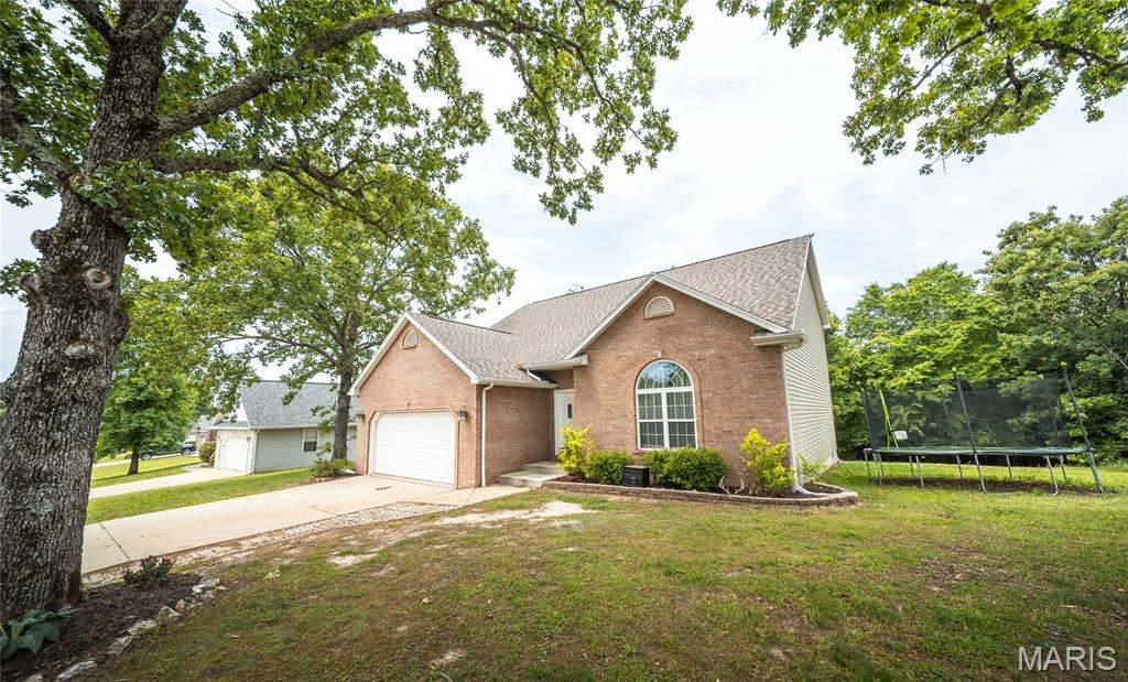 Located in one of the area’s most desirable subdivisions just minutes from Fort Leonard Wood, this stunning 5-bedroom, 2.5-bath home offers the perfect balance of modern comfort, style, and functionality. From the moment you arrive, you will notice the inviting curb appeal and beautifully maintained exterior, including a roof that is less than a year old. Step inside to discover an open and airy floorplan designed for both everyday living and entertaining. High ceilings and abundant natural light create a bright, welcoming atmosphere, while luxury vinyl plank flooring throughout the main living areas adds warmth and durability. The spacious living room centers around a beautiful fireplace, making it the perfect place to gather with family and friends. The kitchen is truly the heart of the home, featuring granite countertops, stainless steel appliances, ample cabinetry, and a walk-in pantry that provides exceptional storage and convenience. Just off the main living area, the oversized deck offers the ideal space for outdoor dining, relaxing evenings, or weekend cookouts. The main-floor primary suite provides a peaceful retreat with a spacious walk-in closet and a beautifully appointed bathroom designed for comfort and privacy. Upstairs, the additional bedrooms feature soft carpeting and flexible space for family, guests, or a home office. This home combines location, space, and modern finishes in one incredible package. Schedule your private showing today and experience everything this beautiful property has to offer!