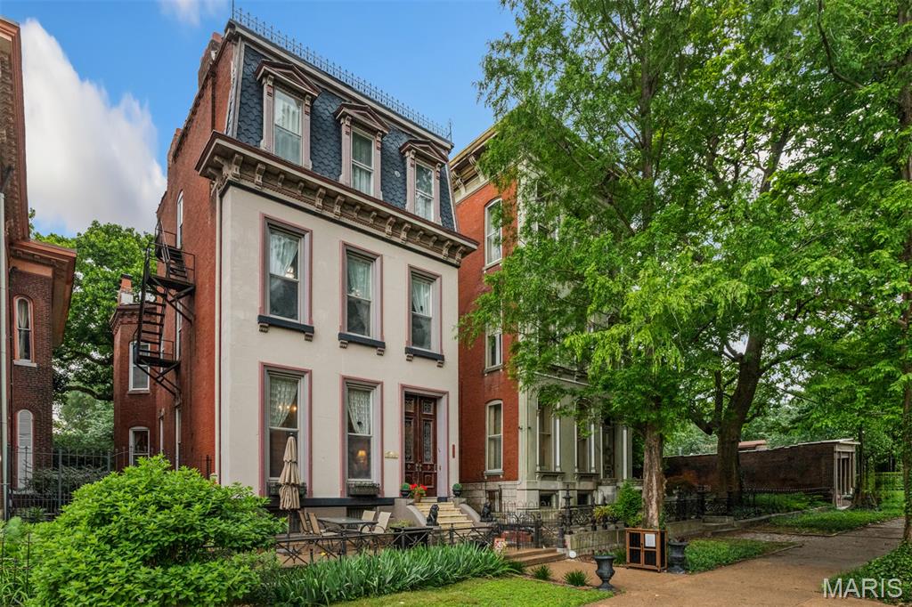 Welcome to 2012 Lafayette Avenue, a timeless Victorian residence perfectly positioned across from the tree-lined walking paths, picturesque lake, and ornate bridges of Lafayette Park. Rich in historic character, this remarkable home has been lovingly maintained by generations of owners who have thoughtfully preserved its original architectural beauty while embracing modern living.
Inside, stunning period details remain beautifully intact, including intricate carpenter’s lace dividing the formal parlors, original pocket doors, floating walnut staircases, matching marble fireplaces and mantels, built-in recessed shutters, and gleaming wood floors throughout. Every space reflects the craftsmanship and elegance of a bygone era.
Outside, the shaded yard offers a peaceful retreat beneath a majestic Tulip Poplar tree, while the inviting front patio provides the perfect setting to relax and enjoy views of the neighborhood and park.
Located in Lafayette Square — St. Louis’ oldest historic district — 2012 Lafayette Avenue offers exceptional walkability to the park, neighborhood events and concerts, acclaimed restaurants, wine bars, and charming local shops. This home is a rare opportunity to experience the beauty of the past while enjoying the vibrancy of today.