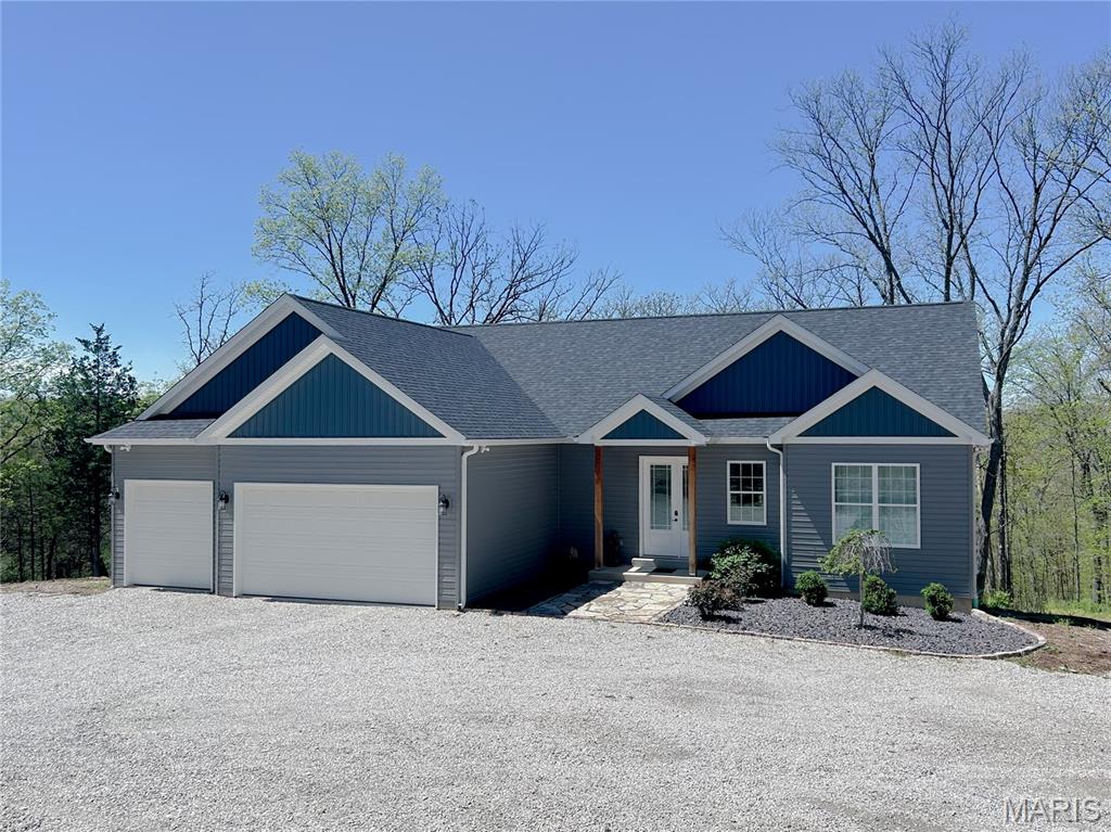 Custom built, beautifully crafted home with over 2,000 sq feet of living space with luxury finishes.  Located on 5 unrestricted acres, mostly wooded, outside New Melle in the heart of wine country.  Private and peacefully located with access to major roads, living in country with easy access to all modern conveniences.  Stepping Inside you are greeted with soaring 10' ceilings, open floor plan from the foyer, great room, kitchen with Quartz countertops, large center Island, walk in pantry, and beverage center in dining area, perfect for entertaining. The primary suite offers a relaxing retreat, custom tiled walk-in showers, soaking tub, WIC. Other two bedrooms and full bath (it also has custom tile work) are located across the great room. The main floor has a laundry room with custom tile, built ins and walks out to the deep, oversized 3 car garage. Open staircase off the foyer opens to an unfinished walk out basement, full bath rough in, just waiting for your endless creativity to personalize it.  Outside you will enjoy the natural stone landscaping and your private woods. Located in the Francis Howell School District. Must have confirmed appointment to show.