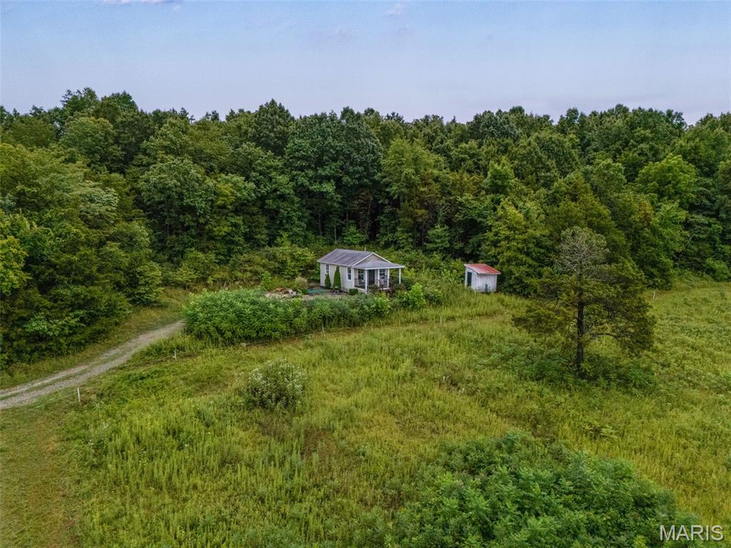 If your idea of the perfect getaway includes a covered front porch, breathtaking views, a cozy cottage, and a whole lot of peace and quiet, stop scrolling because this one is special. Tucked away off the beaten path in Fredericktown, this absolutely adorable 1 bedroom, 1 bathroom cottage sits perched on a hill overlooking approximately 40 acres of beautiful countryside. The covered front porch is the kind of place where you’ll want to linger with your morning coffee, a good book, or a glass of wine while taking in views you simply won’t get tired of. Step inside and it feels like a Pinterest board came to life. Every nook and cranny is packed with farmhouse cottage charm, creating a warm, cozy and inviting space that feels like the perfect escape from the everyday. And the best part? This little beauty is already serving as a successful Airbnb, making it an incredible opportunity for someone looking for a turn-key short-term rental, weekend retreat, or simply a dreamy little place to call their own. Outside, the property keeps getting better with a pond adding even more character and natural beauty to the acreage. Whether you’re looking for an investment opportunity, a peaceful getaway, or your very own slice of country paradise, this property delivers the kind of charm and setting that is getting harder and harder to find. Come for the cottage, stay for the views, and fall in love with the lifestyle.