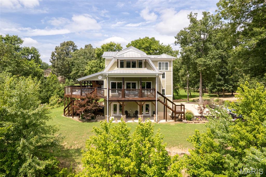 Where Luxury Meets the Flow of the Current River---Luxury Riverfront Living on the Current River---
Experience exquisitely breathtaking riverfront living with 280 ft m/l of pristine Current River frontage, perfectly positioned across from the iconic Bass Rock. This stunning home is designed to showcase the view, with full-length windows spanning the dining area, living room, and kitchen—offering panoramic river vistas that truly take your breath away.
The gourmet kitchen features KitchenAid stainless steel appliances, elegant glass-front cabinetry, a glass-tiled backsplash, and a spacious walk-in pantry, making it as functional as it is beautiful.
The main level includes two bedrooms, a full bath with pebbled concrete flooring, and a convenient laundry room complete with a laundry chute.
Upstairs, the expansive primary suite serves as a private retreat, featuring a sitting area, walk-out balcony, and a spa-inspired en-suite bath. The luxurious bathroom boasts a two-person sauna, a glassed sauna shower with built-in stereo, double vanity, and three walk-in closets.
The lower level offers French doors, a bathroom, and a 2+ car garage, all finished in concrete. The river level is constructed of concrete block with floor drainage, designed for easy clean-up and peace of mind during high water events.   A covered carport area provides additional space for recreational vehicle parking.
Additional 2.10 acres m/l can be purchased with this including a private boat ramp for total price of $1,650,000, totally up to you.
Enjoy outdoor living year-round with approximately 1,800 square feet of decking, perfect for relaxing, entertaining, or simply taking in the serene river views. Park your boat right at the bank and enjoy the river lifestyle to the fullest.
Schedule your private showing today and experience riverfront living at its finest.