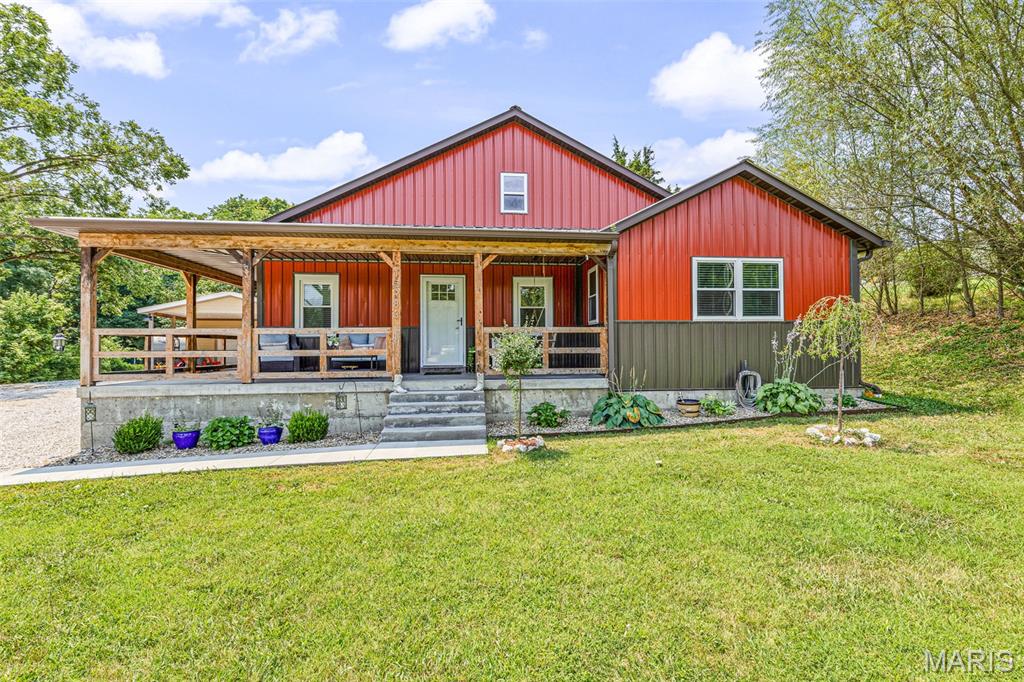 Welcome home to the perfect blend of luxury and rustic charm. From the inviting wraparound front porch to the thoughtfully designed interior, this stunning 3-bed, 2-bath home offers comfort, character, and exceptional craftsmanship throughout. Step inside to an open-concept floor plan featuring custom cabinetry, concrete countertops, a beautiful stone backsplash, and spacious living areas designed for both everyday living and entertaining. The convenient laundry room is located just off the kitchen, while an additional den provides valuable extra living space and showcases a cozy wood-burning stove, creating the perfect gathering spot year-round. The oversized primary suite offers a true retreat with ample space and a custom closet organization system designed for maximum functionality. Outside, the amenities continue with an impressive detached heated shop complete with its own kitchen—ideal for hobbies, entertaining, workspace needs, or additional recreational use. For camper lovers, the property is equipped with both 30-amp and 50-amp camper hookups as well as a convenient dump station, making it easy to accommodate guests or your own travel adventures. Every detail of this property has been carefully considered, offering a unique combination of luxury finishes, rustic appeal, and practical features that are hard to find.  You will appreciate the central boiler system, helping keep utility costs in check while maintaining year-round comfort, this home has a separate well but is on public water also! Make your appointment today!