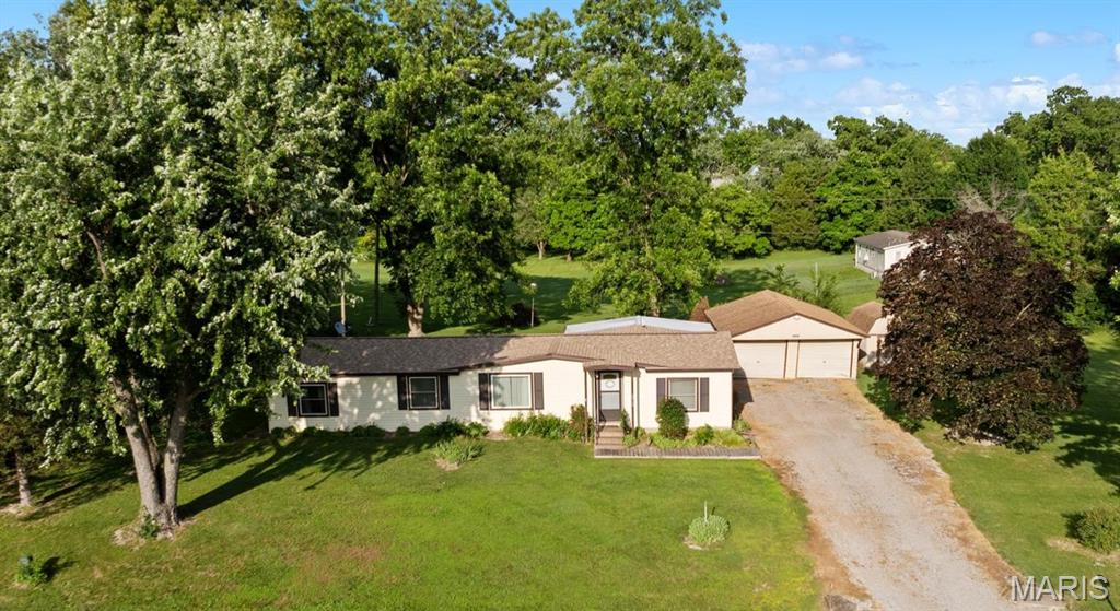 Enjoy the charm of small-town living on a beautifully landscaped, nearly one-acre lot featuring mature pecan trees and plenty of outdoor space to enjoy. Located within the highly regarded Freeburg School District, this unique property offers comfort, character, and opportunity. The one-owner manufactured home, built in 1978, has been thoughtfully updated over the years, including the addition of a sunroom that provides extra living space and views of the picturesque surroundings. A detached garage and storage shed add convenience and functionality. Designed with a desirable split-bedroom floor plan, the spacious primary suite is privately situated on one side of the home and includes a large bedroom and full bathroom. On the opposite side of the home, you'll find a second bedroom, a half bath, and an oversized laundry room that was previously configured as a third bedroom and could offer additional flexibility. The generously sized eat-in kitchen features abundant cabinetry and includes a a refrigerator, stove, and microwave.  A welcoming living and dining room combination provides ample space for everyday living and entertaining. Whether you're looking for a peaceful place to call home or a property with room to make your own, this one is worth a look. Property is being sold in its current condition. Seller will make no repairs and will not provide an occupancy inspection.