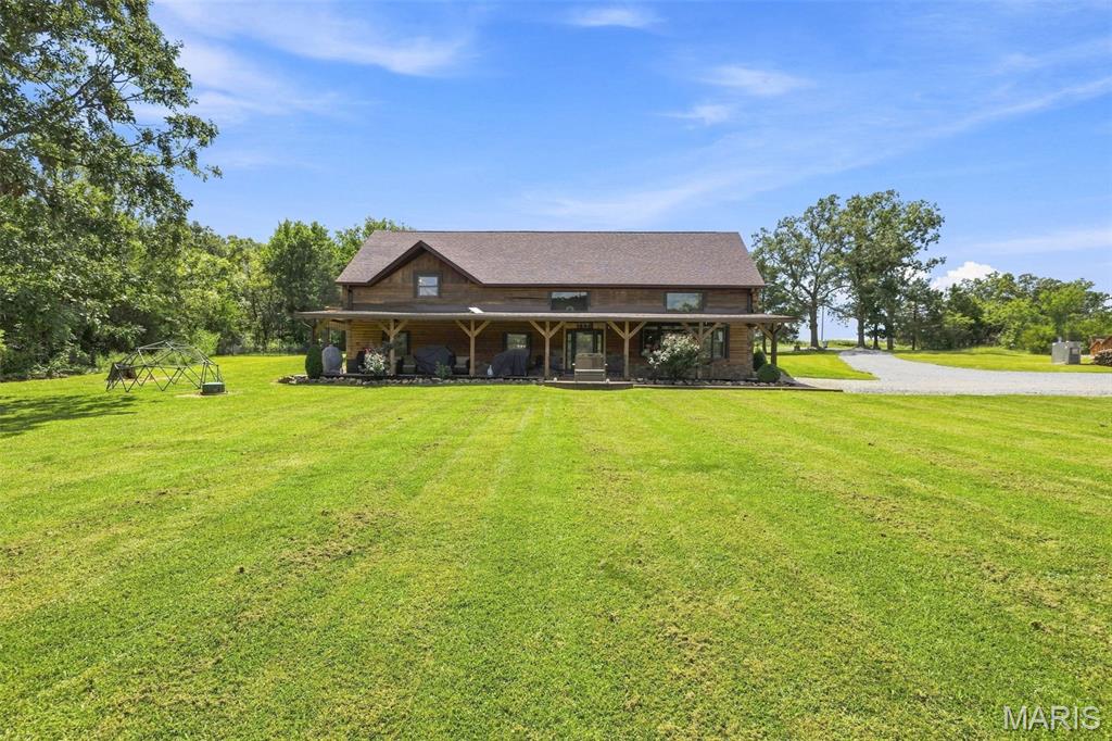 AMAZING Custom Cabin with acreage minutes from Farmington or Fredericktown! Experience the unique charm of this one-of-a-kind, recently renovated log home with luxurious living space set on over 4-acres. Home has amazing views, overlooking Knob Lick Tower Conservation and wildlife are abundant. BRAND NEW oversized 40 X 60 out shop with 14 ft ceilings and 10 X 12 doors, able to house even the largest of tools and toys! Property has a back up generator that is capable of running everything, outdoor woodstove and HEATED FLOORS! ONE OF A KIND- CUSTOM chicken/duck coop, able to house 20+ animals! 25' ceilings, grand staircase, custom balcony, loft, LARGE Master suite, custom bath, private back porch with views! Step outside to a beautifully manicured yard, perfectly positioned at the edge of a conservation area, ensuring privacy and tranquility. Surrounded by picturesque farms, this home offers a peaceful retreat away from the hustle and bustle. The main floor boasts an expansive open floor plan, ideal for entertaining and family gatherings, complete with custom woodworking and exquisite stonework that showcases craftsmanship. A striking exposed loft adds character. This completely remodeled home blends modern amenities with the charm of rustic living, making it a sanctuary that truly feels like a getaway. Adjoining 12 acre property could also be bought. Don’t miss the opportunity to own this slice of paradise!