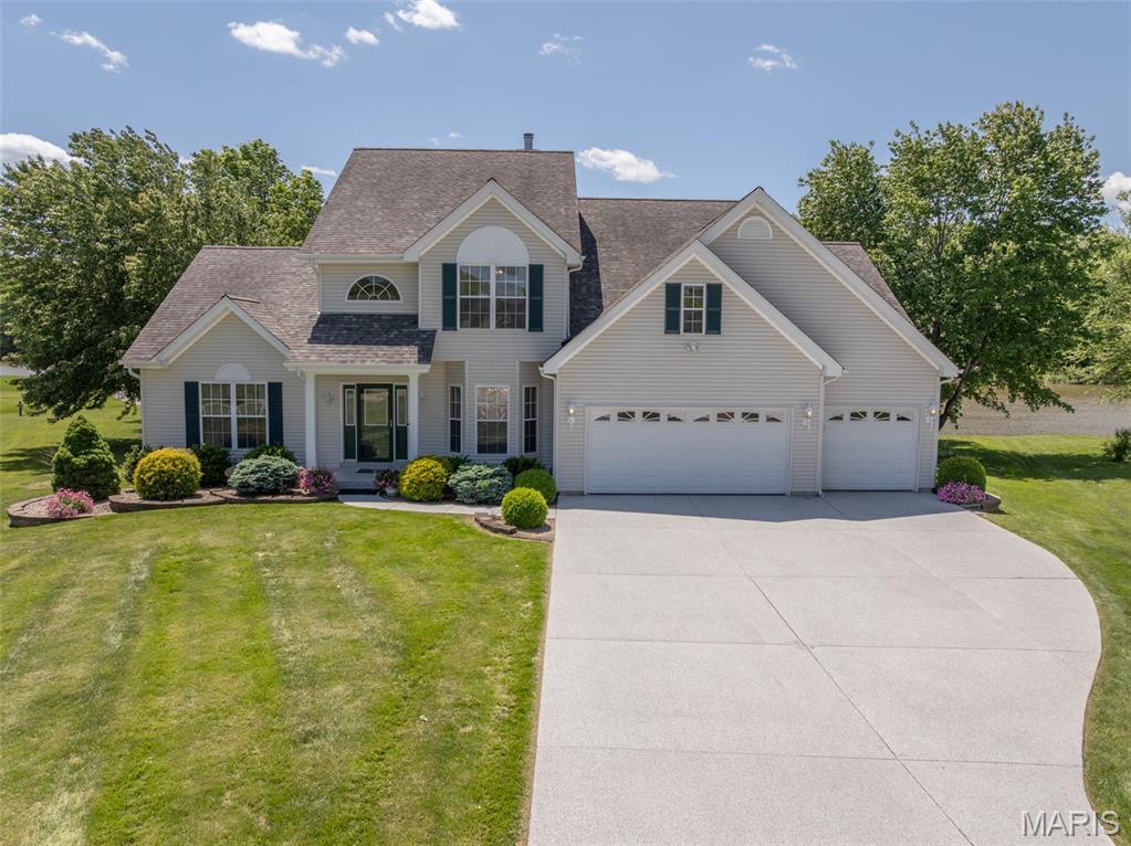 Experience premier lakefront living just 15 minutes from Wentzville. Positioned on one of the subdivision's largest 1/3-acre lot, this expansive 4400+ sq. ft estate commands 165 feet of calm on the no-wake end of the lake. Complete with a private boat dock, a flat walk-out lawn and unobstructed sunset views. This property offers an unmatched resort lifestyle. Your waterfront backyard gives you easy access to fishing, boating, paddleboarding or kayaking. The spacious home has room for a weekend gathering with 4 spacious bedrooms, a loft area and multiple entertaining areas on the main level.  A main floor primary suite with vaulted beamed ceiling offers a great retreat for owners with a luxury bath with lake views and a sizeable walk-in closet. 18 foot ceilings and a wall of windows welcome guests into the main entertaining area that then flows to the breakfast/kitchen area with ample cabinets, island breakfast bar and a dual sided fireplace between. Just off this area is a big 4-season room with independent heat and cool, giving you someplace to enjoy your lakeview year-round. The private flex room with access to the deck makes an excellent private home office. Also on the main floor is a formal dining that could be a conversation area or a home office with the change of a light fixture. There is also an efficient main floor laundry with cabinets & a sink located near the garage. Upstairs is great for kids or guests with a nice size loft complete with a library area with bookshelves, 3 bedrooms and an updated bath with a large shower. Over 4400 square feet to enjoy with dual heat and air systems, a 3-car garage, private boat dock and a big flat yard that walks out to the water. What are you waiting for? This one has room for everyone and waterfronts are rare especially on the no-wake end! People love Incline as a full time residence or for week-end fun with several lakes, a clubhouse & party pavilions available to rent, community pool, pickleball, swimming beach and a public golf course. Plus the activities like Band on the Beach events in the summer, the spectacular 4th of July Fireworks Display, golf cart parades, water aerobics, winter bingo, paint & sip events, fishing tournaments and this year a Cardboard Boat Regatta - it is not just a subdivision with beautiful lakes & golf it is a Lifestyle - make it what you want!