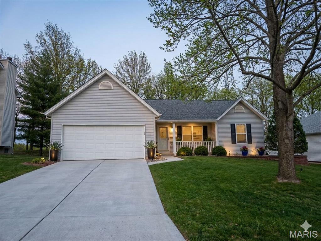 Welcome home to this beautifully maintained home in the highly sought-after Francis Howell School District! Situated on a truly unique lot backing to the golf course — yet not directly part of the golf course property — this home offers the rare combination of scenic views, added privacy, and freedom from typical golf course restrictions or obligations.

This open concept ranch offers approximately 2,779 total square feet of thoughtfully designed living space, blending comfort, style, and everyday functionality. The large eat in kitchen features a vaulted ceiling and a charming breakfast nook framed by bay windows—an inviting spot for morning coffee or casual meals. The adjoining great room continues the airy feel with its matching vaulted ceiling, skylights that flood the space with natural light, a cozy wood burning fireplace, and rich hardwood style laminate flooring that extends through the kitchen, dining area, entry, and hallway.

The spacious primary suite is a true retreat, offering an oversized bedroom, a custom walk in closet system for maximum organization, and serene golf course views. The en suite bath includes a double bowl vanity, jetted spa tub, and separate shower. Two additional bedrooms and a convenient main level laundry area complete the first floor.

The partially finished lower level expands your living options with a large multi functional space—ideal as a family room, home office, or game room—complete with a wet bar/kitchenette featuring a sink and beverage refrigerator. A separate large room provides space for a guest sleeping area or additional office, paired with a half bath. The unfinished portion offers extensive storage, built in shelving, and a dedicated workshop with workbench.

Outdoor living shines with a large deck overlooking a stunning, unobstructed golf course view, offering spectacular sunrises and peaceful evenings without the noise of backyard neighbors. Situated behind Tee Box #5 on the private Persimmon Woods Golf Club, this premium tee box location ensures panoramic views for dining outdoors or enjoying a quiet fire.

The HOA provides exceptional amenities including a clubhouse, multiple pools, tennis courts, and pickleball.