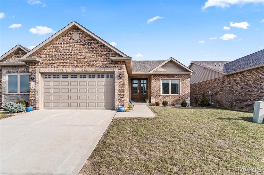 Beautiful brick villa nestled on the north end of Columbia with gorgeous views and scenic sunsets. This sprawling attached villa is less than 5 years old, so you can enjoy worry free living while skipping the wait of new construction. Inside, craftsmanship can be found throughout. The main level has an open concept and includes the custom kitchen with granite counter-tops and center island w/ breakfast bar, white shaker cabinets, recessed lighting with beautiful fixtures, pantry, stainless appliances and separate main floor laundry room.  The primary suite has wide double door entry, deep walk-in closet, and en-suite full bath with luxury tub, dual sink vanity, and walk-in shower. A guest bedroom and full hall bath can also be found on the main level. Walk out to a covered rear patio to soak up some sun and relax on quite nights. The lower level has a 9ft pour and has been finished to include a large rec room, 3rd bedroom and 3rd full bath, while still have tons of extra storage in a large unfinished area with room for expansion. This one owner home is fresh, clean and move-in ready.  Why spend more on new construction when this Villa is in pristine condition & conveniently located on the North End Of Columbia.