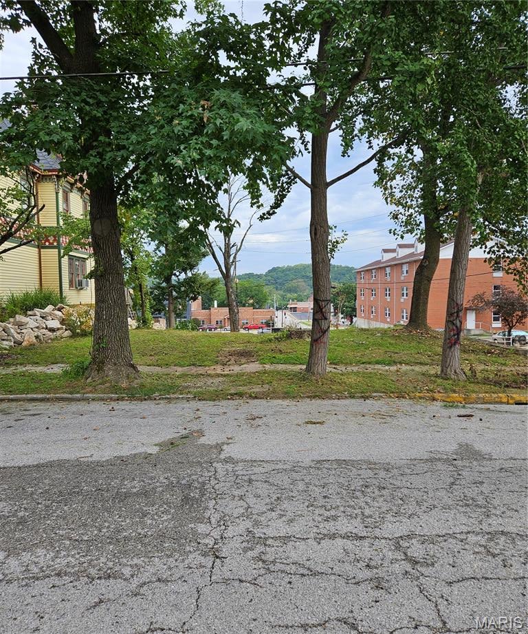 A lovely home with lots of history used to be located here, but sadly it was destroyed by a fire. Of course, all of the utilities are available. So maybe you would like to build your new home here, or you may have other needs for a city lot. Either way, this corner lot may be just what you've been looking for because it is zoned commercial! So call city hall for guidance and get started! It is located just a block off Broadway & just behind the courthouse. Take a look.