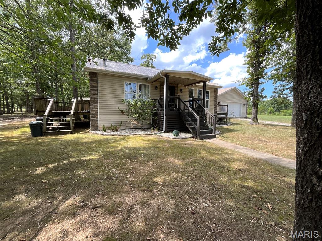 4BD/2BA Custom Built with lots of storage. Open Floor Plan. Large Bedrooms, With large closets. The Living Room has a free standing wood-burning FP. Large windows for lots of light. The kitchen has a tile backsplash and a beverage cooler built in. Newer dishwasher and refrigerator. Double Oven. Breakfast bar with over-the-counter lighting. Rock Front. Walk-in Pantry with Laundry room, walks out to a  2 car oversized garage. Includes a 30 x 30 shop with a concrete floor, 200 AMP electric service, set-up frame machine, storage shed and chicken coop. All is fenced for your livestock and a private winding drive. Less than 1/2 off of Z hwy. CLose to Mark twain National Forest