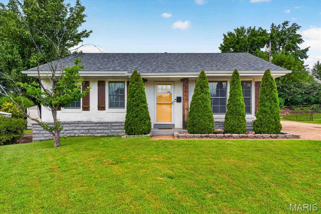 Welcome home to this stunning south city bungalow! This beautiful all-brick ranch blends timeless character with stylish updates and incredible curb appeal. Step inside to a spacious living room highlighted by crisp, clean shiplap accents and luxury vinyl plank flooring throughout. The updated kitchen is a standout with custom 42-inch white cabinetry, granite countertops, stainless steel appliances, and abundant storage. A nicely sized island perfectly connects the living and kitchen space to enhance the open concept design. Originally a three-bedroom home, the floor plan has been reimagined to offer an oversized primary suite with generous closet space and a versatile sitting area perfect for a home office, nursery, or reading nook. A generously sized second bedroom with a charming wainscoting accent wall and a beautifully renovated full bath complete the main level. The finished lower level expands the living space with a large recreation room, built-in bar, bonus room / office, second full bath, and plenty of room to entertain, relax, or work from home. Outside you'll find the large, flat backyard already fenced and comes with an outdoor storage shed. Situated on a quiet cul-de-sac with an expanded / multi car driveway providing room for up to 6 cars. This South City gem is just a short walk to Carondelet Park, offering the perfect combination of neighborhood charm, outdoor recreation, and modern comfort. NEW ROOF 2024! *Interior photos coming 7/22*