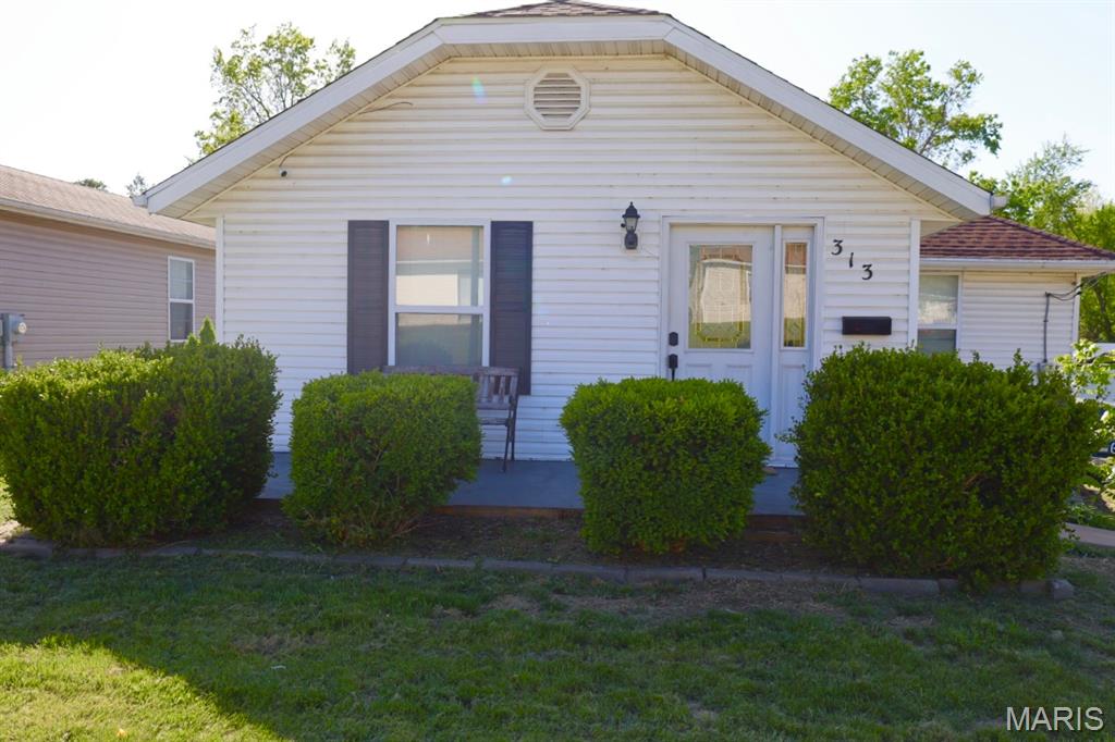 CUTE AS A BUTTON bungalow just a hop, skip & a jump from historic downtown Festus main street and the main business areas of shopping and restaurants! Great curb appeal with an adorable little front patio, perfect to sit and sip your morning coffee and watch the world go by! Upon entry you're greeted by hardwood floors that flow throughout the open floor plan! Fresh paint throughout most of the living areas! Brand new flooring in the bathrooms! Recently updated kitchen with breakfast bar and NEWLY installed recessed lighting! ALL Kitchen appliances stay! The walk-out, partially finished lower level offers a great bonus room! Lower level could be finished out for MORE living space! Main level laundry and a nice laundry/mud room! And don't forget to check out the HUGE back deck that offers 500 Sq. Ft of outdoor entertainment space! Primary bedroom also has it's own private deck entrance! This home is situated a great large lot! The back yard offers plenty of space for the family and pets to roam and play! Plant that garden you've always wanted, put up a pool, build your dream garage, or leave it natural and just enjoy the view from your back deck! Schedule your appointment to see this ADORABLE home TODAY!