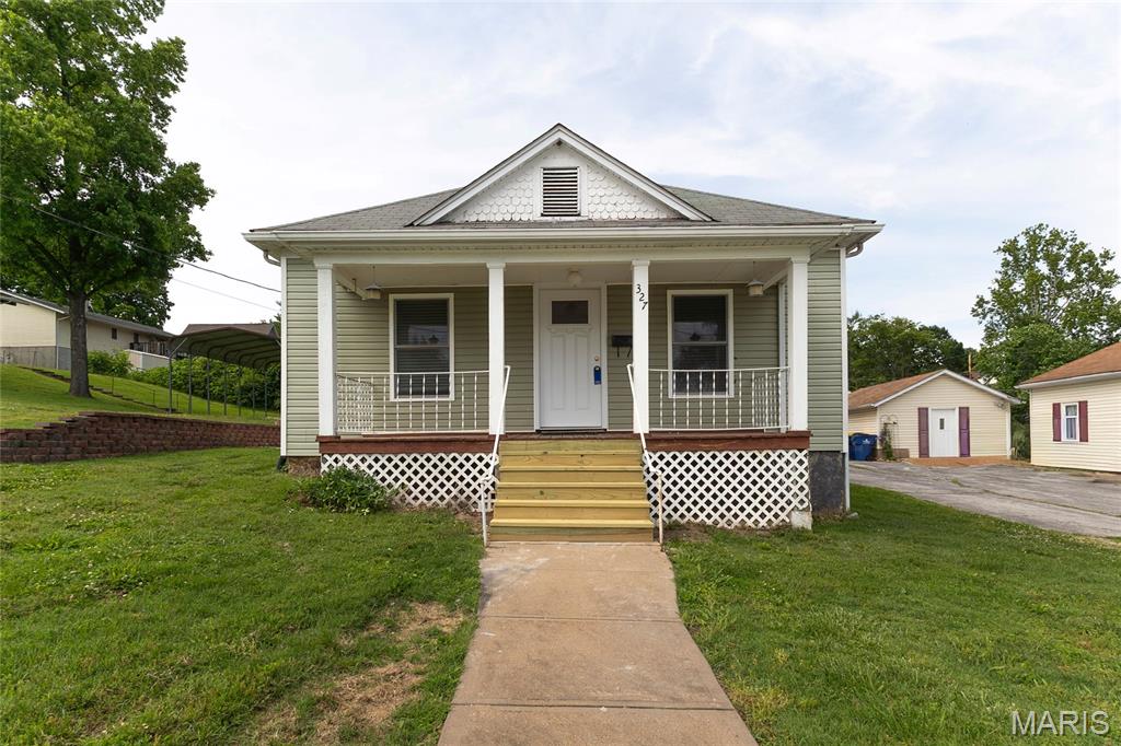 Charming and completely renovated, this 4 bedroom, 2 bath home is perfectly situated in the heart of Festus, just minutes from downtown shopping, dining, parks and all the activities and charm of historic Festus.  Renovated in 2022, this move-in ready home blends modern updates, with timeless character and offers comfortable living spaces throughout.  The spacious layout features an open floorplan, four bedrooms, two full baths, main floor laundry, updated finishes and plenty of natural light.  Step outside to enjoy the level backyard, ideal for entertaining, gardening, pets or play, along with a detached one car garage for added convenience and storage.  With its walkable location and extensive renovations already completed, this home offers the perfect combination of convenience, comfort and small town charm.  Not to mention the covered front porch for relaxing on those beautiful weather days on this very quiet street.  Make an appt to see this gem, you won't be disappointed in this one.
