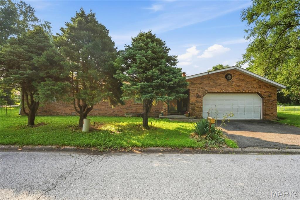 Investors and bargain hunters here is your chance to buy a wonderful brick ranch home needing some TLC.  This well built home sits on a large corner lot and is located near interstate 255.  The home has an open concept with the living room/dining room and kitchen all open making it perfect for entertaining.  The living room host a nice full brick fireplace.  You will find two bedroom and a bath along with a primary suite all on one level.  The attached garage and asphalt driveway makes this an ideal property for those wanting easy maintenance and covered parking.  The home will need a new roof and the interior needs TLC.  Don't miss out on this gem!  Buyer and buyer's agent to verify all information. Property is being sold 100% AS IS. Seller will not do any inspections, repairs, or credits for repairs.  Seller will not turn utilities on.