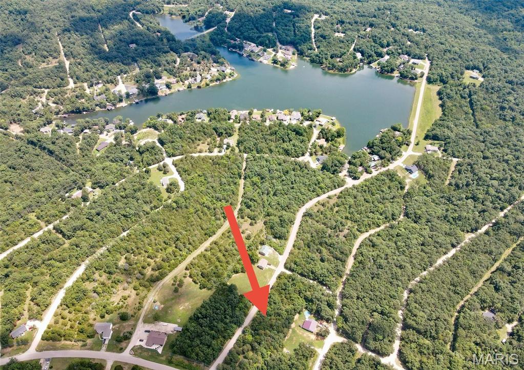 Escape the hustle and build your custom home on this beautiful, vacant lot on paved road only steps away from Lac Lafitte. Enjoy the peace, security and all Terre Du Lac amenities including boating, fishing, golf, river access and much more. Your dream home starts here!