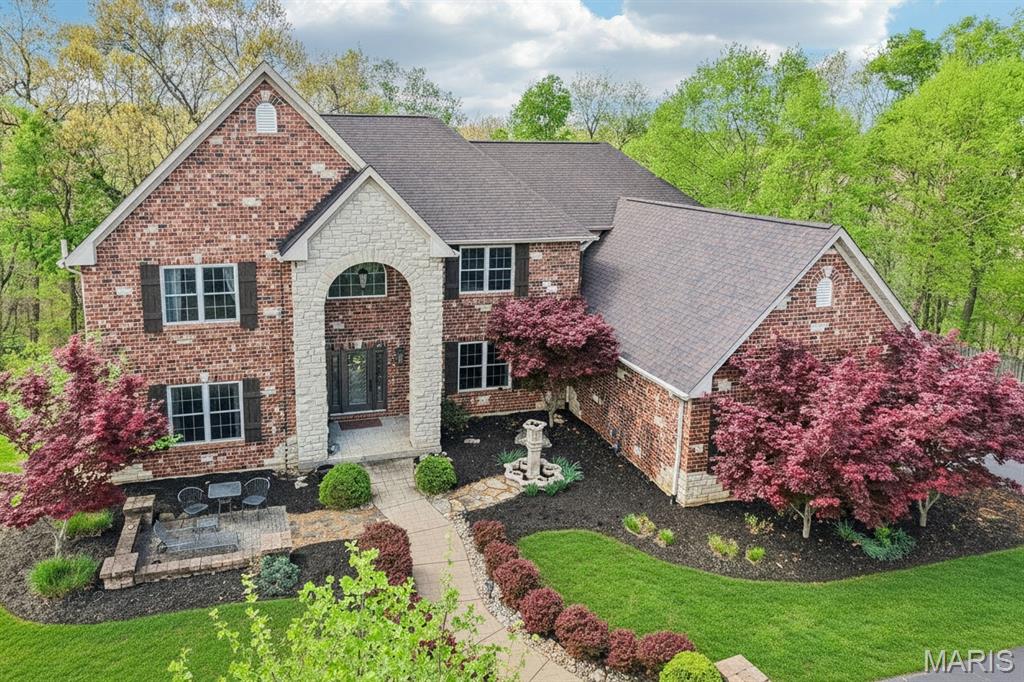 OPEN HOUSE CANCELLED Tucked within an exclusive gated community in desirable St. Louis County and located in the award-winning Rockwood School District, this stunning brick and stone estate offers luxury, privacy, and exceptional indoor-outdoor living on 3 acres. A circle driveway and side-entry 3-car garage create an impressive arrival, while the private, fenced backyard backing to mature forest provides a peaceful escape. Entertain with ease in the thoughtfully designed outdoor spaces featuring a biergarten, pergola, newer covered deck, stamped patio, and included hot tub.
Inside, a dramatic 2-story entry opens to a breathtaking great room with gas fireplace and a wall of windows showcasing serene views. The grand staircase with wrought iron spindles makes a statement, while the formal dining room features cased, arched openings and a coffered ceiling with crown molding. A private den offers a quiet workspace, and the expansive kitchen boasts a center island, granite countertops, double ovens, and glass display cabinetry. The main floor primary suite is a true retreat with a bay window, coffered ceiling, and a spa-inspired bath designed for relaxation, plus convenient main floor laundry with sink.
Upstairs, bedrooms 2 & 3 share a bath with double vanities, offering both comfort and functionality, while bedroom 4 enjoys easy access to a hall bath—ideal for guests or family. A spacious upper-level family room with French doors and a Juliet balcony overlooks the great room below, creating an open, connected feel perfect for everyday living or entertaining. The finished walk-out lower level expands your living space with a rec rm featuring a bar, dedicated theater room for movie nights, a private 5th bedroom, and full bath—perfect for guests, multigenerational living, or a private retreat. Thoughtful updates include new paint (2020), garage doors/openers (2021), humidifier (2023), deck (2023), and architectural roof with gutter guards (2024), 220 Outlet to exterior, Double Oven and some lighting.
******The main route off 44/141 will be closed until Mid-May (Beautiful Road Improvements on the way!) For Now...you'll need to take the back roads in via Hwy 30 until this project is completed in MAY 2026.***** See updated notes regarding offer deadlines*****