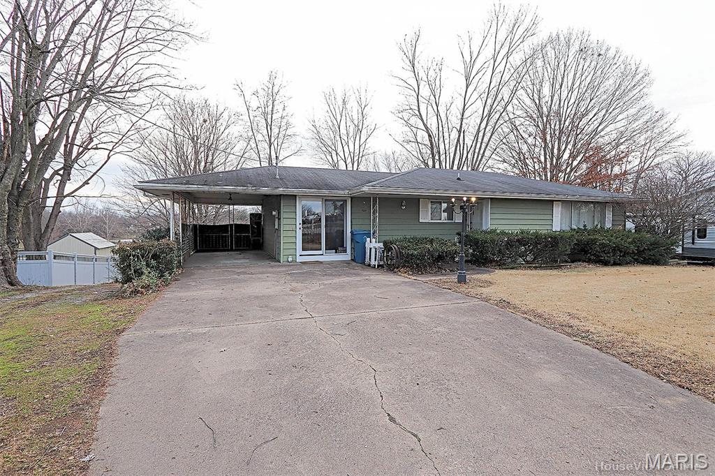 This 3 bed 2 bath ranch home sits on a spacious & 1/2 acre+ lot in Jackson School District, offering room to stretch out, grow, and enjoy small-town living outside the city limits.  Step inside to find the original hardwood flooring preserved beneath the carpet, ready to shine again. The cozy den features a gas log fireplace, perfect for movie nights or morning coffee.  The full finished walkout basement is a standout bonus—complete with a kitchenette, bedroom, full bath, and private access. Whether you need space for a parent, a college kid, a teenager, or a rental-style efficiency setup, this lower level delivers flexibility and privacy.
  For all your hobbies, storage, and tinkering needs, you’ll love the workshop/garage area in the basement, PLUS a detached 24x24 shop/garage out back. Vehicles, tools, toys—bring them all.  The large lot provides plenty of outdoor usable space with room for gardens, pets, play, and future projects.
