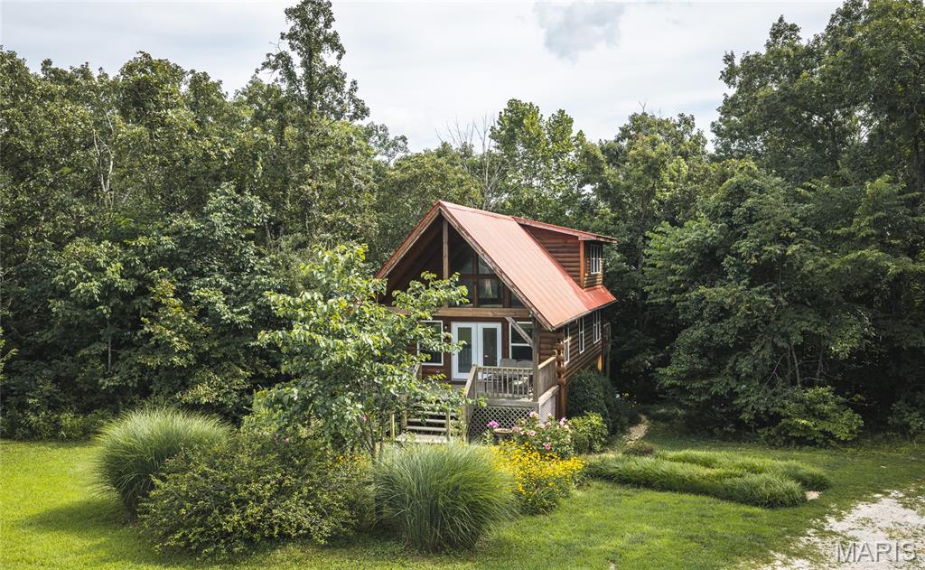 Log Home Retreat on Thurman Lake Rd — Steelville, MO. Escape to easy living at 108 Thurman Lake Rd, a beautifully maintained log home tucked into the woods on 5.62 wooded acres just outside Steelville. Sold fully furnished — hot tub included — this 1,610 sq ft, 4-bedroom, 2-bath retreat is ready for family, friends, and firelit evenings on the deck.
This home has built a loyal following as a vacation rental for years. The furnishings, layout, and location are already dialed in if you want to keep the income flowing — or make it your own weekend escape or full-time residence. Either way, you're less than a mile from Scott's Ford public access on the Meramec River and just 5 miles from Meramec Spring Park, with Historic Route 66 and Steelville's everyday conveniences close by. St. Louis is just over an hour out.
The property sits on subdivided land, currently served by a shared well — and the price includes installation of a brand-new private well, so the next owner starts clean.