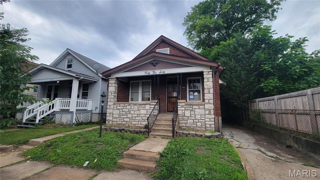 OUTSTANDING OPPORTUNITY!!! So much potential here!  Bring your work boots and your creativity and make this one shine once again!  All brick bungalow features covered porch, wood floors, fenced yard, and MORE!  Detached garage, large deck, solid wood doors, original stained glass and rear bonus room make this one a WINNER! Schedule a showing today! Property is to be sold in its current as-is condition with no warranties or representations by the Seller. Seller will not make repairs nor provide any inspections. Seller's addendum is required after terms of sale are agreed upon. Special Sale Contract (Form #2043) required. Proof of funds or pre-approval letter required with offer.
