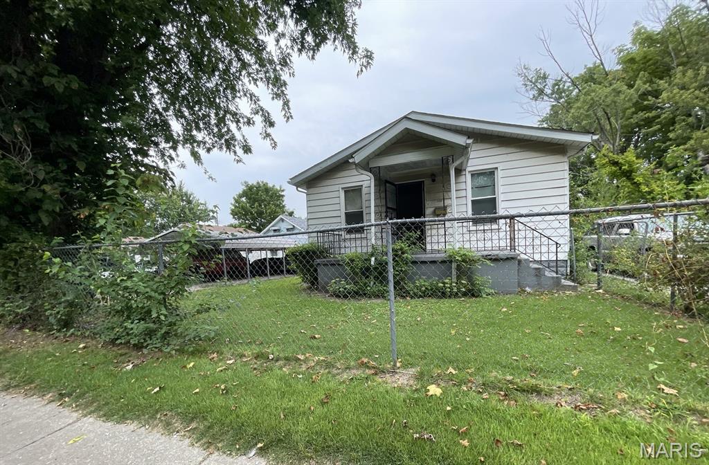 Welcome to 823 N 80th Street in East St. Louis. This property offers a traditional two-bedroom, one-bathroom layout with a covered front porch and a detached one-car garage. The front door opens into the living room, providing access to the main living areas. The kitchen, two bedrooms, and full bathroom are all located on the main level, along with a rear mudroom that offers additional utility space and access to the back of the home. The full basement is unfinished. Outside, the covered front porch provides a welcoming entry area, while the detached one-car garage offers additional parking or storage potential. This property presents an opportunity for buyers seeking a home with a manageable main-level layout and the potential to make it their own. Property details, dimensions, permitted uses, and all information should be independently verified by the buyer and buyer's agent.