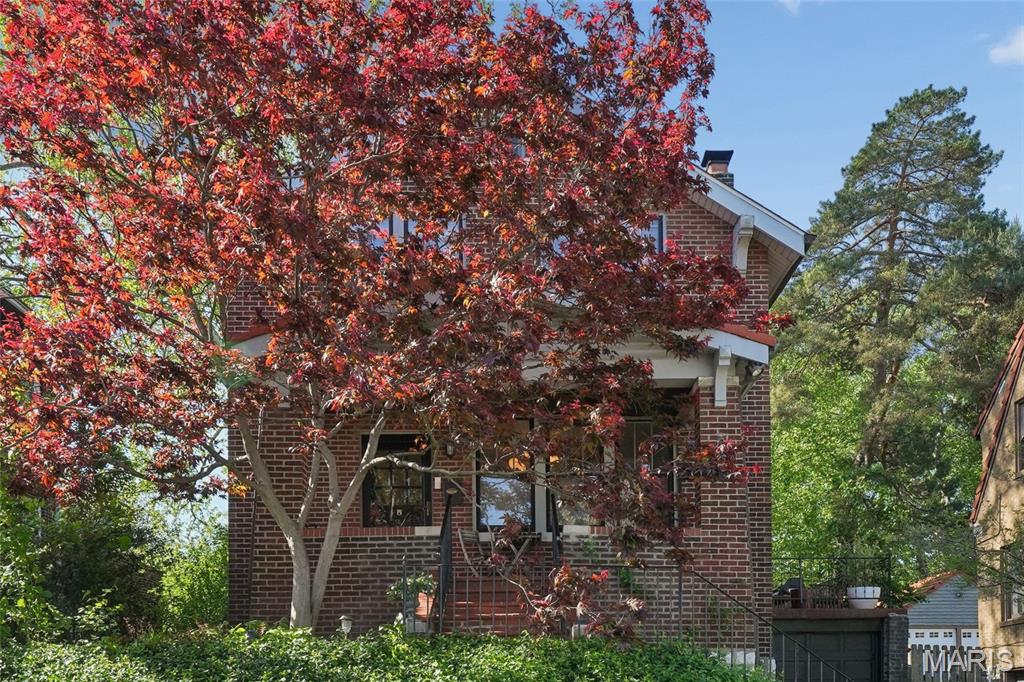 Charming two-story, three-bedroom home featuring a remodeled kitchen with granite countertops, custom cabinetry with glass fronts and unlacquered brass hardware, gas cooktop, stainless steel appliances, and soft-close drawers. Distinctive details in the home include stained-glass windows, wood floors, a wood-burning fireplace, and preserved historic character.  Recent updates include a new roof (2023), and a new boiler (2024). The porches, patio, and large, level, fenced backyard offer excellent outdoor spaces for entertaining.  Walkable to downtown Clayton and ideally located just steps from popular restaurants. Convenient access to WashU, Forest Park, and major highways, providing short commutes to downtown, West County, and the airport.