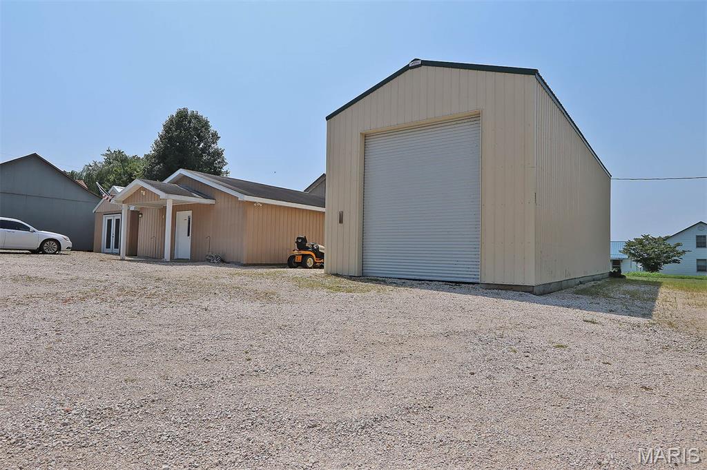 Remarkable building with many possible use options. Extensive remodeling, upgrading has been completed. The main building features over 2500 sq ft with central heat, air, and small storm cellar. 2 bathroom and a separate ceramic tiled shower. Full kitchen facilities, large custom bar. There is a 3 year old 20 x 50 metal shop building with 16 ft walls which be leased for additional income. Large enough for RV storage. This would be great location for a bar, restaurant, catering business, daycare, antique store, many possibilities or could easily be converted to a private residence. There are no known restrictions to the possible uses. Duplicate listing of MLS 26052265.