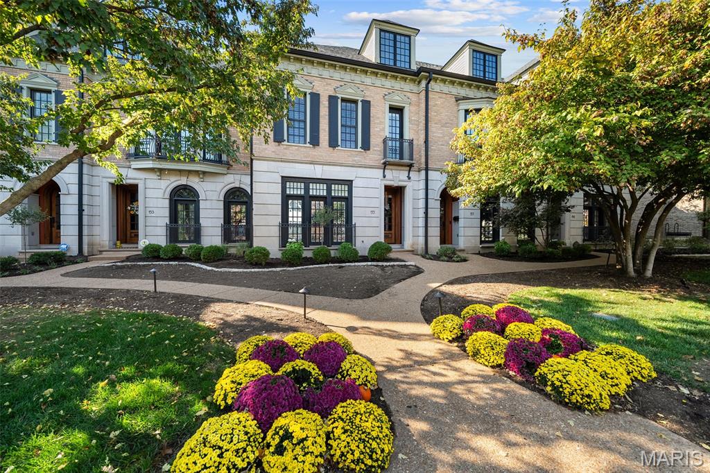 A showpiece of refined living in the heart of Clayton, this exceptional luxury residence has been fully reimagined with sophisticated elegance and magazine-worthy style. From the moment you step inside, every detail whispers quality, comfort, and quiet glamour—soaring ceilings, designer lighting, fresh flooring, and exquisite custom finishes throughout. The gourmet kitchen is a stunning centerpiece, featuring sleek white cabinetry, quartz counters, soft-close features, and professional-grade appliances including Wolf range—all framed by warm hardwoods and timeless millwork. Sun-filled living and dining spaces create an effortless flow for entertaining and everyday enjoyment, with French doors opening onto your own private oasis. Outdoors, the courtyard patio offers resort-style living with a retractable awning, elegant lounge area, and a custom putting green—perfect for morning coffee, evening wine, or weekend gatherings with style. Retreat upstairs to a serene primary suite boasting a custom walk-in closet and a spa-inspired bath with Brizo fixtures, frameless glass shower, and stone mosaic flooring. Additional bedrooms and beautifully renovated baths continue the home’s elevated design and thoughtful comfort. Located just steps from Clayton’s premier dining, boutiques, parks, and business district, this home is the very definition of luxury meets lifestyle. Exquisite and purely captivating—welcome home.