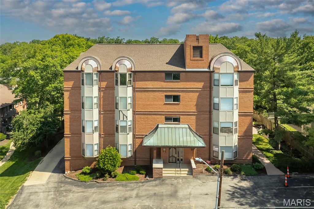Enjoy park views from this desirable third-floor end-unit condo in the popular Jefferson Manor building! This 2-bedroom, 2-bath home offers easy one-level living with an open floor plan, abundant natural light, in-unit laundry, and scenic views. The kitchen opens into the large dining/living room area with a bay window and the primary bedroom is spacious and bright with plenty of windows, a walk-in closet, an additional closet and ensuite bath.  A second bedroom and full hall bathroom are adjacent to the primary suite. A great opportunity to add your personal touches and build value in a quiet, well-maintained community. Ideally located near Kirkwood Park, you’ll enjoy convenient access to walking trails, green space, sports facilities, Stages St. Louis, and all the charm of downtown Kirkwood. Just minutes from local restaurants, shops, and everyday conveniences, this location blends comfort with lifestyle. Additional amenities include secure entry, elevator, underground parking, and extra storage. New roof June 2026 and beautiful copper trim now being installed.
