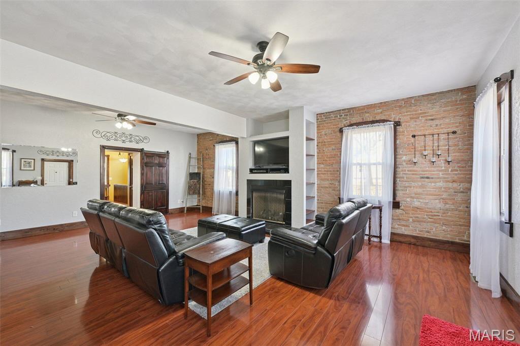 TRULY RARE FIND! Modern living meets historic charm in this move-in ready 3-bed, 2-bath spacious home full of character and thoughtful, structural updates. A stunning living room features a full wall of exposed brick, a gas fireplace w/blower, and custom built-ins. A Jefferson staircase leads to an upstairs retreat, with built-in bookcases, a window seat, and abundant storage.
Kitchen updates include a large storage island, prep station w/recycling center, drink station and pantry. Great room connects the kitchen in an open floor plan for awesome entertaining. All appliances, plus pool table w/hardtop stay.
Outside, a 16' x 38' covered patio, 11' x 54' stamped concrete patio, fire pit area, and barbecue zone are great for hosting in any season. 
Extras: 2019 asphalt roof, new Trane HVAC system w/3-zones, 1.5-car detached garage with carport, garden shed, and 2016 12' x 20' lofted shed with garage door-great for a street-legal golf cart. Must see to appreciate!