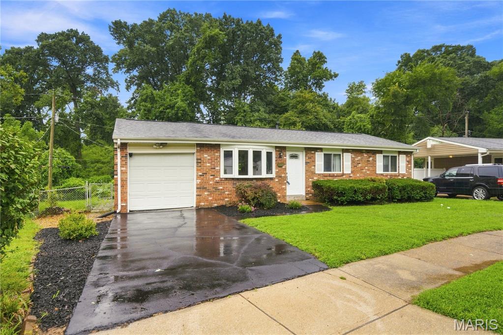 Move right into this beautifully refreshed Affton-area ranch where the updates are done and the memories are waiting to be made! The bright, open floor plan seamlessly connects the kitchen and living room, creating an inviting space that's perfect for everyday living and entertaining. Sunshine pours through the home, highlighting the refinished hardwood floors and fresh interior paint in Benjamin Moore's timeless Linen.
The cheerful kitchen features crisp white upper cabinets, stylish blue lower cabinets, light gray walls, white Formica countertops, and a full suite of kitchen appliances that were replaced in 2020. The hardwood floors were sanded and refinished in 2020, adding warmth and character throughout the main level.
The finished lower level offers even more room to spread out with a spacious recreation area, bar with an included microwave, and a fun chalkboard wall that's perfect for kids' artwork, family game nights, Pictionary, tic-tac-toe, and more. The washer and dryer are also included, making this home truly move-in ready.
Outside, enjoy a large fenced backyard that backs to a peaceful creek, offering a private setting for relaxing, gardening, or entertaining. Recent improvements include a new water heater (July 2026), freshly sealed driveway (August 2026), and fresh interior paint throughout. With thoughtful updates, flexible living space, and a fantastic backyard, this home is ready to welcome its next owners!