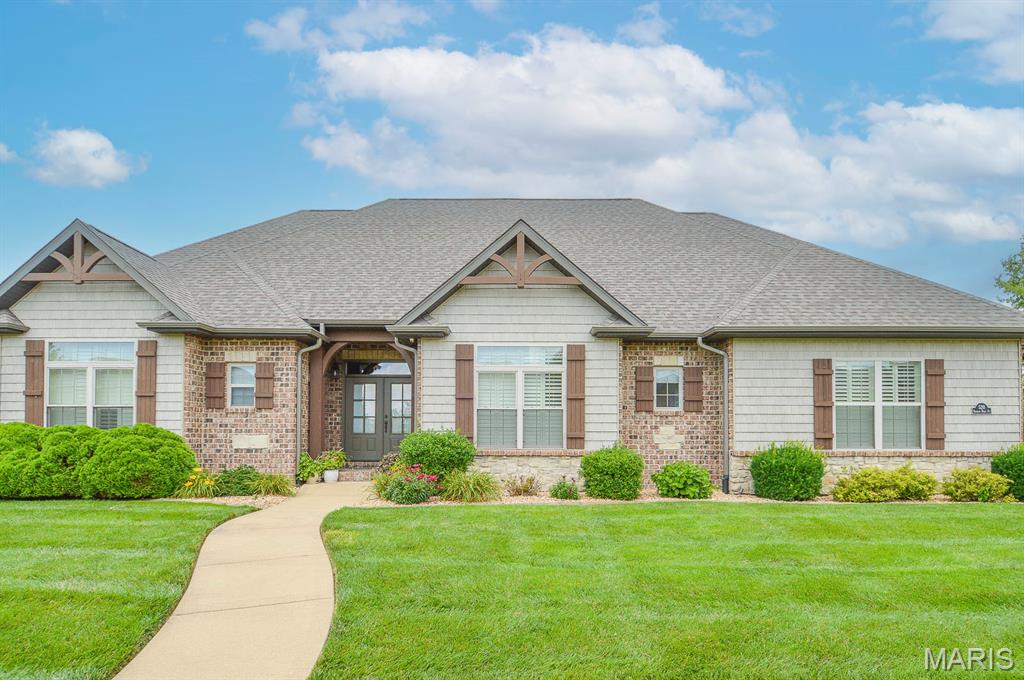 Welcome home to 520 Shadow Rock Court. This 4,000+ square foot ranch home offers a spacious open floor plan with 5 bedrooms and 4 full bathrooms. The Great Room features Cathedral Ceilings with Floating Beams and a Stone Fireplace from Floor to Ceiling. Eat-in-Kitchen has Cambria Quartz Counters, Custom Built Glazed Cabinetry, Stainless Steel Appliances, Decorative Backsplash, a Large Island that opens to the Great Room and a Breakfast Area which overlooks a 16x14 Covered Patio. Crown Molding flows through the Kitchen, Breakfast Area and Foyer. The Master Suite has double entry doors and a Lighted Tray Ceiling. Open the Barn Doors and enter the Master Bath which has ceramic tile floors, a walk-in shower with cultured marble base and tiled walls, a separate soaking tub with Backsplash, dual sinks, and a large walk-in closet. All bedrooms have large walk-in closets. Bedrooms 3 & 4 are connected by a Jack-n-Jill bath with dual vanities and a separate shower. The basement consists of 1300+ square feet of living space and includes a bedroom, full bathroom, living room, a wet bar and a ton of storage. The property is beautifully landscaped with mature trees that provide optimal privacy. There is a versa lock retaining wall in the backyard that is ideal for a future pool installation. Some recent upgrades to the home include a brand new roof and gutters, plantation shutters, brick paver sidewalk and patio along with fresh paint throughout the main level. Make your appointment to tour today!