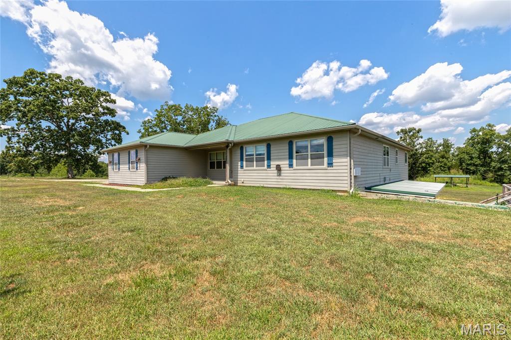 This is your "Chance of a Lifetime" to own THE Ultimate 250 Acre Missouri Cattle Ranch!! Nestled at the end of a quiet Country Road, this Working Cattle Ranch is turn-key and ready for you to bring/build your own Herd!  As you drive through the Large, Arched Gate Entrance you will gaze upon the Crown Jewel to this Ranch ~ the Spacious 6 Bedroom Estate. Fully Loaded with an over-sized Gourmet Kitchen, with abundant Counter space, High-end appliances, HUGE Center Island with extra seating, expansive windows throughout for Amazing Panoramic views over the landscape, with beautiful Natural light flowing throughout. A curated Lifestyle, a perfectly calm-ambiance for growing Plants, Enjoying Nature, Relaxation & Gratitude. Savoring the views from your Kitchen Windows, you can Look out over your Livestock, & notice abundant Wildlife all around. The large Covered back-porch is perfect for sitting outside and and enjoying the breeze. This Home has it all! Walking downstairs you will find a wet-bar, Living Room, 2 full Bedrooms, Man-Cave w/ Walk in Gun-Safe and Armored Vault Door. A Basement door also leads out to the Outdoor Wood Furnace/Boiler for additional warmth in the Winter, Energy efficiency, and low Utilities. You can also Hop right into the Hot Tub and sooth those sore Muscles after a long day working the Ranch. Last but not least- A Large Barn for Livestock, Hay, Equipment Storage. PLUS a Brand new Mobile home placed, for the Ranch Hand to stay right there when needed.