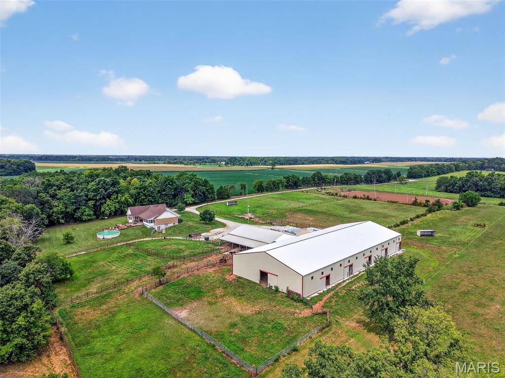 Motivated Seller! Equestrians Dream Estate on 24+ sprawling acres! Welcome to your private country retreat. Step inside this beautifully maintained ranch home to a spacious, open floor plan featuring 4beds/4 full baths, vaulted ceilings, expansive living area,  a large kitchen island, formal dining room & main floor laundry. A partially finished walk-out basement offers additional living space with kitchenette, bonus room, & rec room. The 3 season porch is perfect for morning coffee or just relaxing, while the large patio, deck & above ground pool will be the highlight of family celebrations. With over 5600sqft of finished living space the possibilities are endless.  Horse lovers will fall in love with the thoughtfully designed, heated barn, complete with 8 spacious 12x16 stalls, a large tack room, wash stall and full bathroom.  Ride year round in the impressive 80x200 indoor riding arena, take advantage of the 150x250 outdoor arena or let your horses enjoy the expansive, fully fenced turnout pastures. The back pasture has a small pond, and gently rolling landscape.  Just minutes from Hwy 70 and only 45min to Lambert airport!
