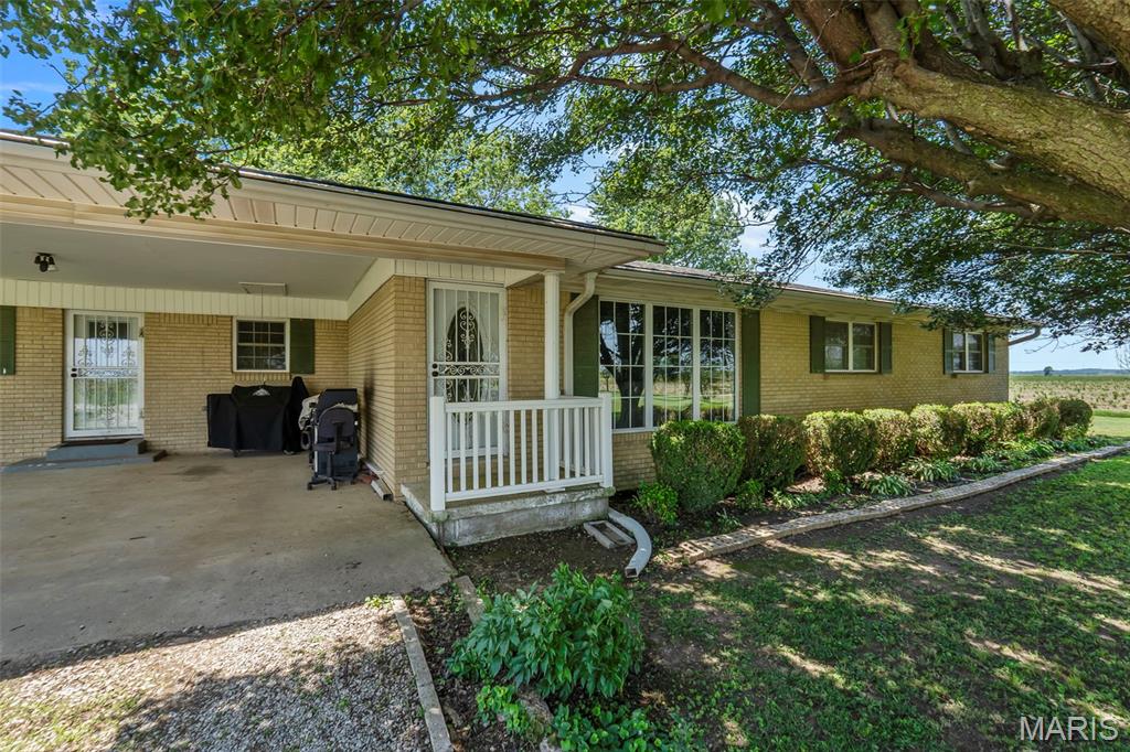 Looking for a country oasis with acreage? Take a look at this very well maintained 4-bedroom 1 bath home sitting on 2.36 acres. Located only a few minutes away from the modern conveniences of town with no neighboring houses. The custom-built kitchen cabinets are gorgeous! New flooring was recently installed throughout most of the house as well as updated paint & modern finishes. The sunporch is the perfect spot to sit & take in all of the beautiful nature surrounding this property! The enclosed porch area previously had a 2nd bathroom- this would be a great spot to convert back to a 2nd bathroom for guests. The large shop has full electricity & a bay door. The grain bins can be rented out for additional income or even converted to storage, modern grain bin gazebos, or grain bin patios! So much beautiful, serene space for outdoor living! Call today for your personal tour of this countryside property!