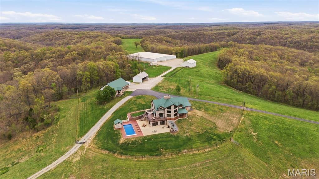 Discover an extraordinary opportunity in Southeast Missouri: a breathtaking almost 800-acre ranch estate that perfectly blends luxury living, agricultural potential, and unmatched privacy.

At the heart of the property sits a stunning almost 6,000SF custom stone and timber home, thoughtfully designed with timeless craftsmanship and modern comforts. From its expansive living spaces, 20’ cathedral ceilings to its refined finishes, the 5 bed 5 bath residence offers both elegance and functionality—ideal for entertaining guests or enjoying the ranch and peaceful country living.

A standout feature of the property is the remarkable 26,000SF climate controlled, fully equipped sports complex—perfect for recreation, training, events, or repurposing to suit your vision (originally built as an indoor roping arena). In addition, the ranch includes multiple meticulously maintained shops and storage facilities, ensuring exceptional organization and functionality for day-to-day operations.

Built with serious ranching in mind, the property is outfitted with well-maintained cattle working equipment, steel pipe fences, ponds, lakes, spring fed year-round streams, making it turnkey for livestock management and agricultural production.

The land itself is a rare find—almost 800 contiguous acres of rolling terrain featuring a mix of open pasture, wooded areas, and natural beauty. Perfect for cattle, horses, hunting, or recreation, the property offers endless possibilities for agricultural use or a private retreat and borders over 14,000 acres of the Mark Twain National Forest. 

Located in the scenic landscape of Southeast Missouri wine country, this ranch delivers both seclusion and accessibility, making it a true legacy property.

Photo and Video Link (copy and paste into browser) - https://listings.studio724photography.com/sites/rojkbmpv/unbranded

This is more than just a ranch estate—it’s a place to build a future, create memories, and invest in a lifestyle few properties can match and would take over a lifetime to reassemble.