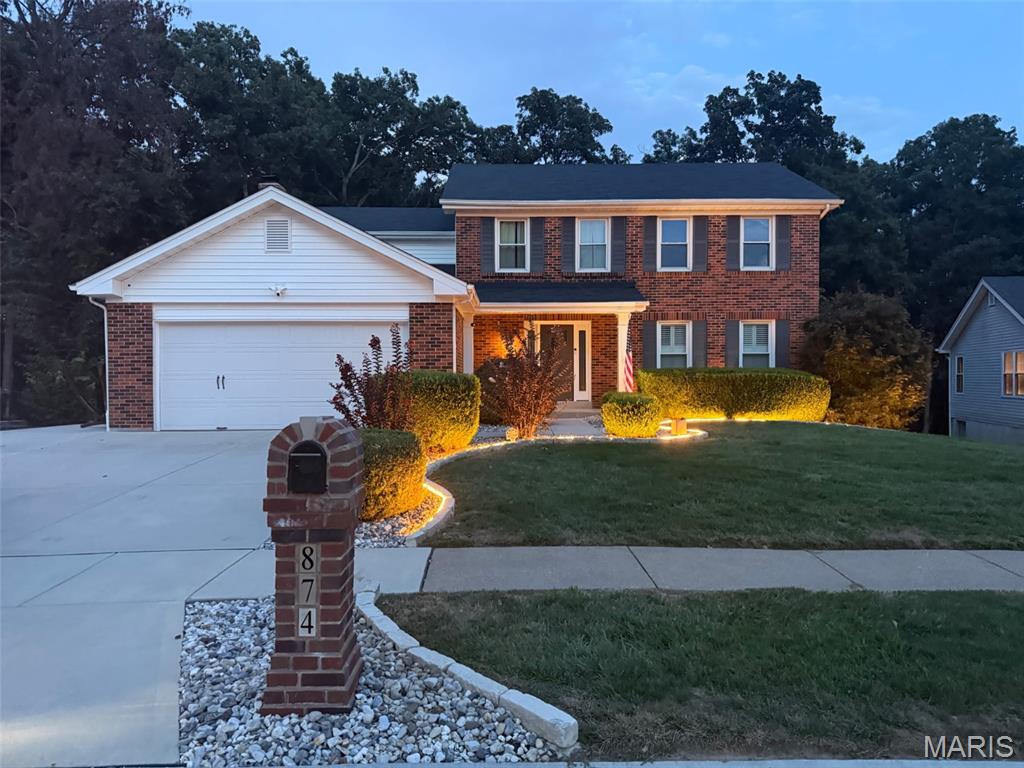 Welcome home to this tastefully updated and meticulously maintained two-story in the desirable Big Bend Woods North Subdivision. From the moment you arrive, the impressive curb appeal, manicured lawn, and beautiful landscaping set the tone for what awaits inside. Step into the inviting foyer, where a show-stopping staircase makes an immediate impression. The main level features neutral paint, luxury vinyl plank flooring throughout, and a spacious living room accented by classic plantation shutters. They say the kitchen is the heart of the home, and this one does not disappoint. Enjoy granite countertops, updated cabinetry and lighting, stainless steel appliances, a pantry, breakfast bar, and adjoining breakfast room. The layout flows seamlessly into the comfortable family room featuring a wood-burning fireplace, creating an ideal space for everyday living and entertaining. Sliding glass doors lead to the extended patio overlooking the mostly level, tree-backed yard, perfect for morning coffee, weekend gatherings, or relaxing evenings outdoors. A generously sized separate dining room provides plenty of space for hosting holidays and special occasions. A convenient main-floor laundry room located just off the two-car garage completes the main level. Upstairs, you’ll find all four bedrooms and two full bathrooms. The spacious primary suite offers a walk-in closet and private full bath with shower. Three additional bedrooms feature generous closet space and share an updated hall bathroom. The partially finished lower level adds even more versatility, with multiple areas that can easily accommodate a home office, fitness space, recreation room, playroom, or whatever best fits your lifestyle. Ample unfinished storage adds even more functionality. Extensive updates include an extended driveway, landscape lighting, Ring alarm system, newer windows, sliding glass door, siding, soffits, shutters and fascia, LVP flooring throughout the main level, an expanded rear patio pad, shed pad, refinished lower level, and newer HVAC. Located in sought-after Big Bend Woods, homeowners also have the option to join the Big Bend Woods Bath & Tennis Club. Enjoy convenient access to award-winning Parkway Schools, major highways, shopping, dining, and entertainment. With thoughtful updates, generous living space, and a fantastic location, this home is truly move-in ready and waiting for its next chapter.